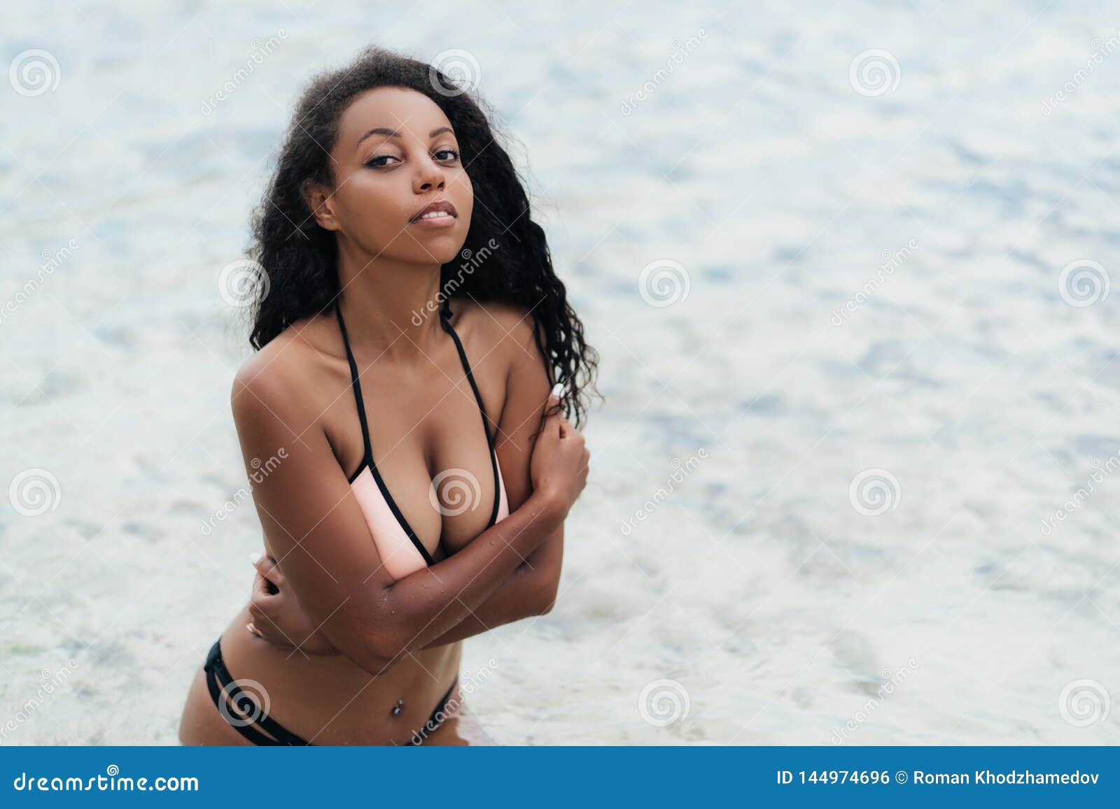 Portrait of Dark Skinned Afro American Girl with Big Breasts on Beach photo