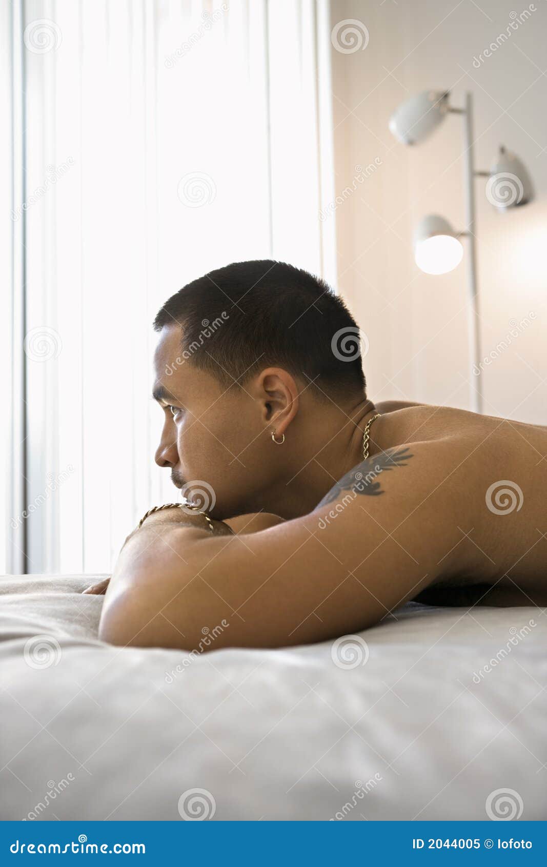 Portrait Of Shirtless Man Lying On Bed. Stock Image - Image: 2044005