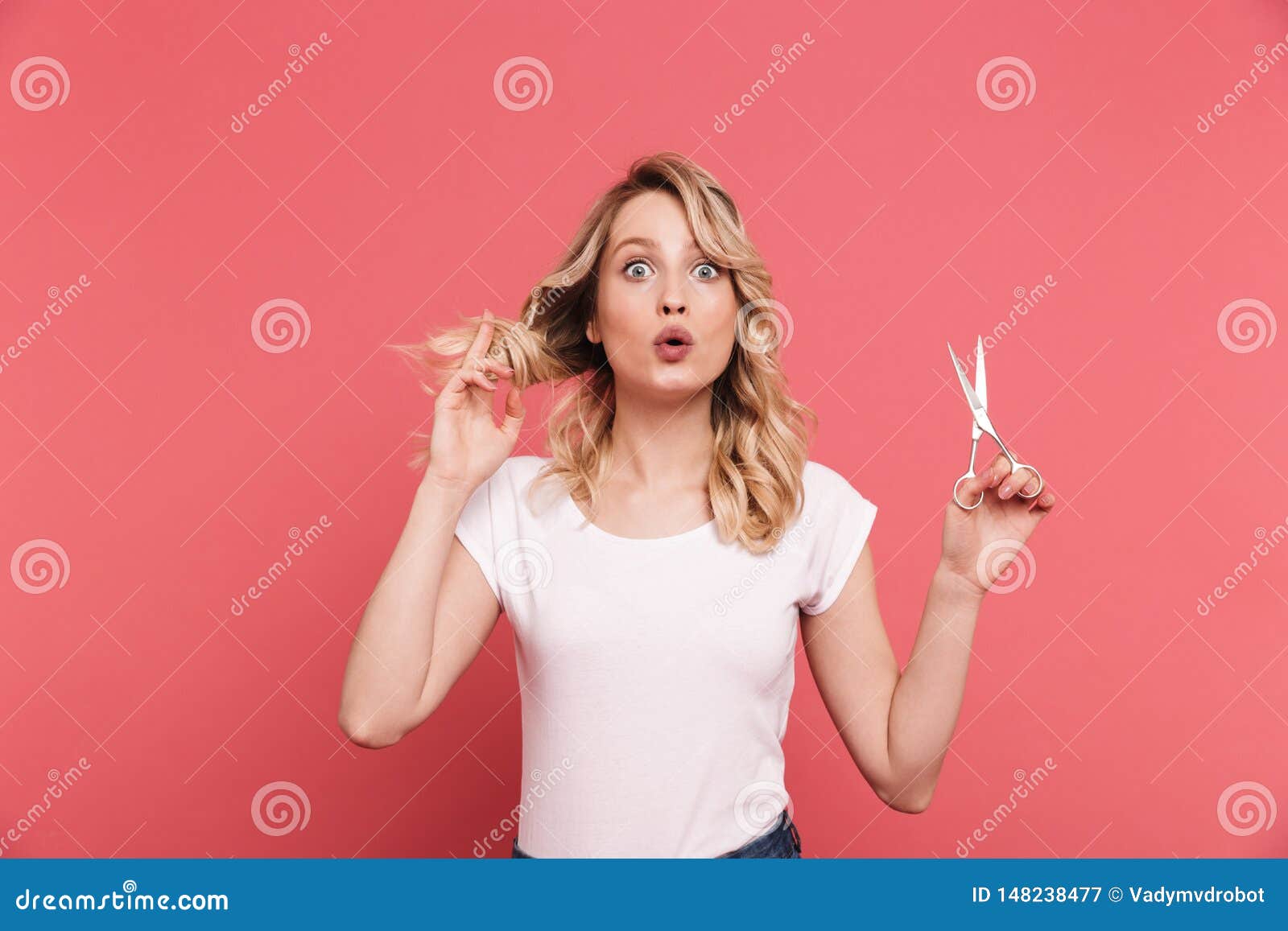 Girl cuts shirt with scissors