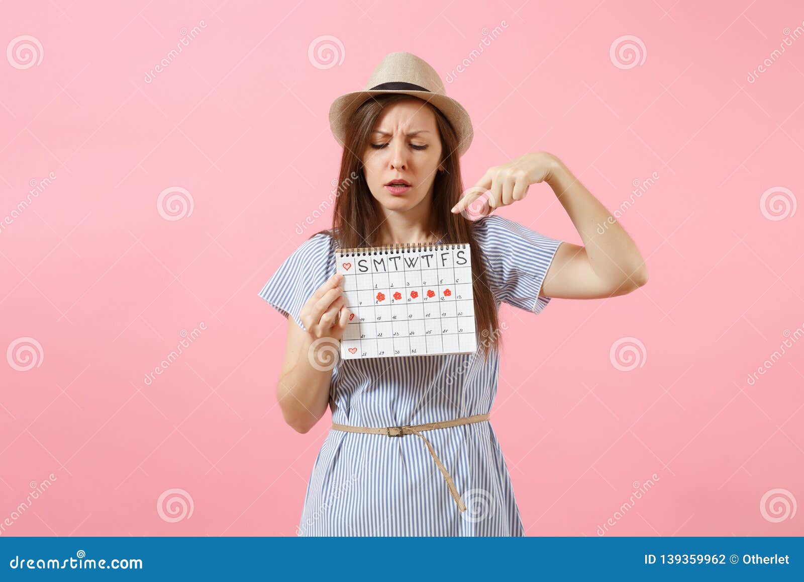 Portrait Of Shocked Woman In Blue Dress Hat Holding Periods Calendar