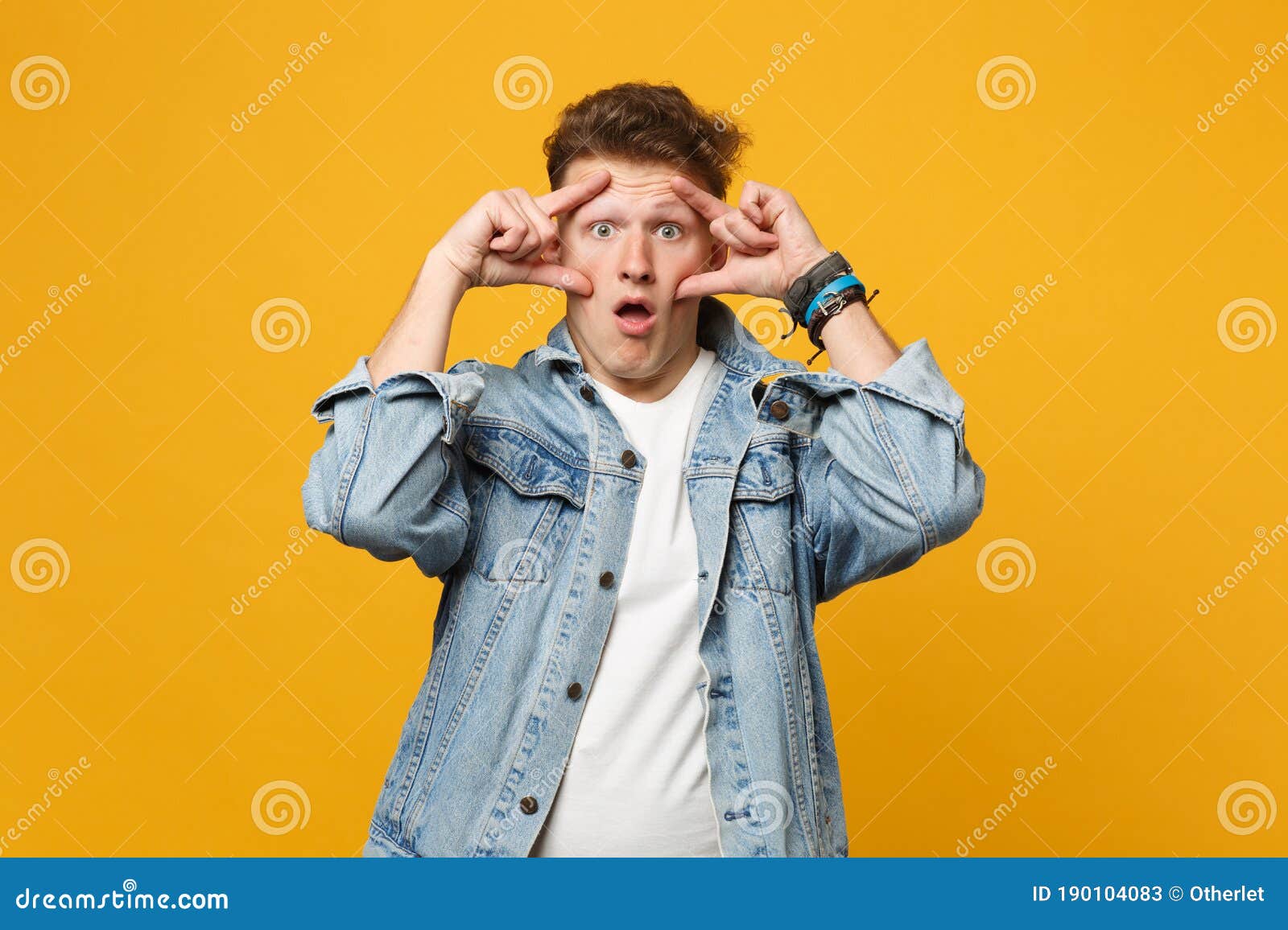 Portrait of Shocked Young Man in Denim Casual Clothes Keeping Mouth ...