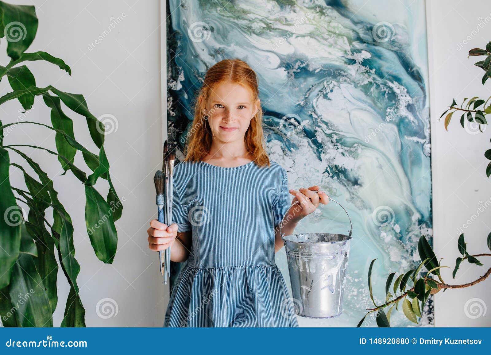 Portrait Of Shy Teenage Redhead Girl With Bunch Of Brushes In Hand