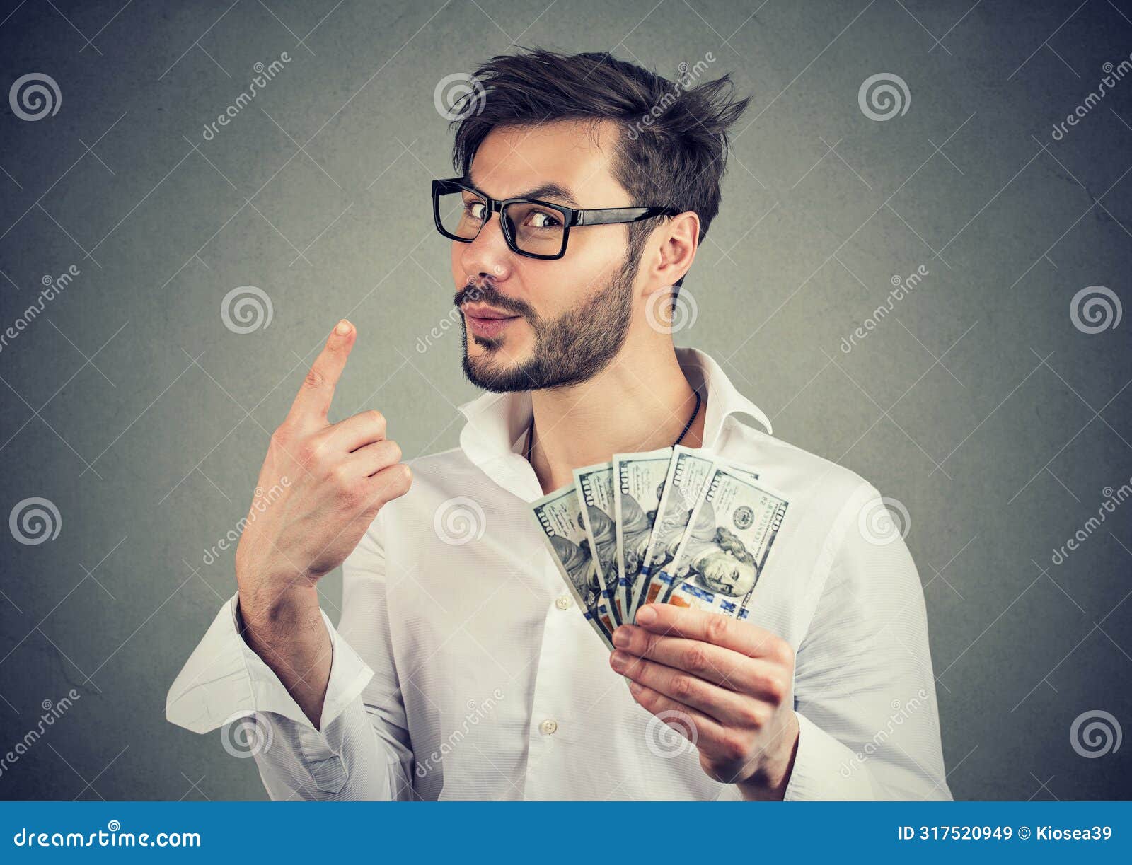 portrait of a sly business man with hundred dollar bills giving one piece of advice