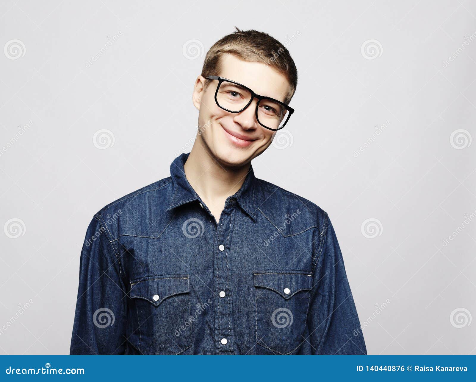 Portrait Of A Smart Young Man Wearing Eyeglasses Standing Against White ...