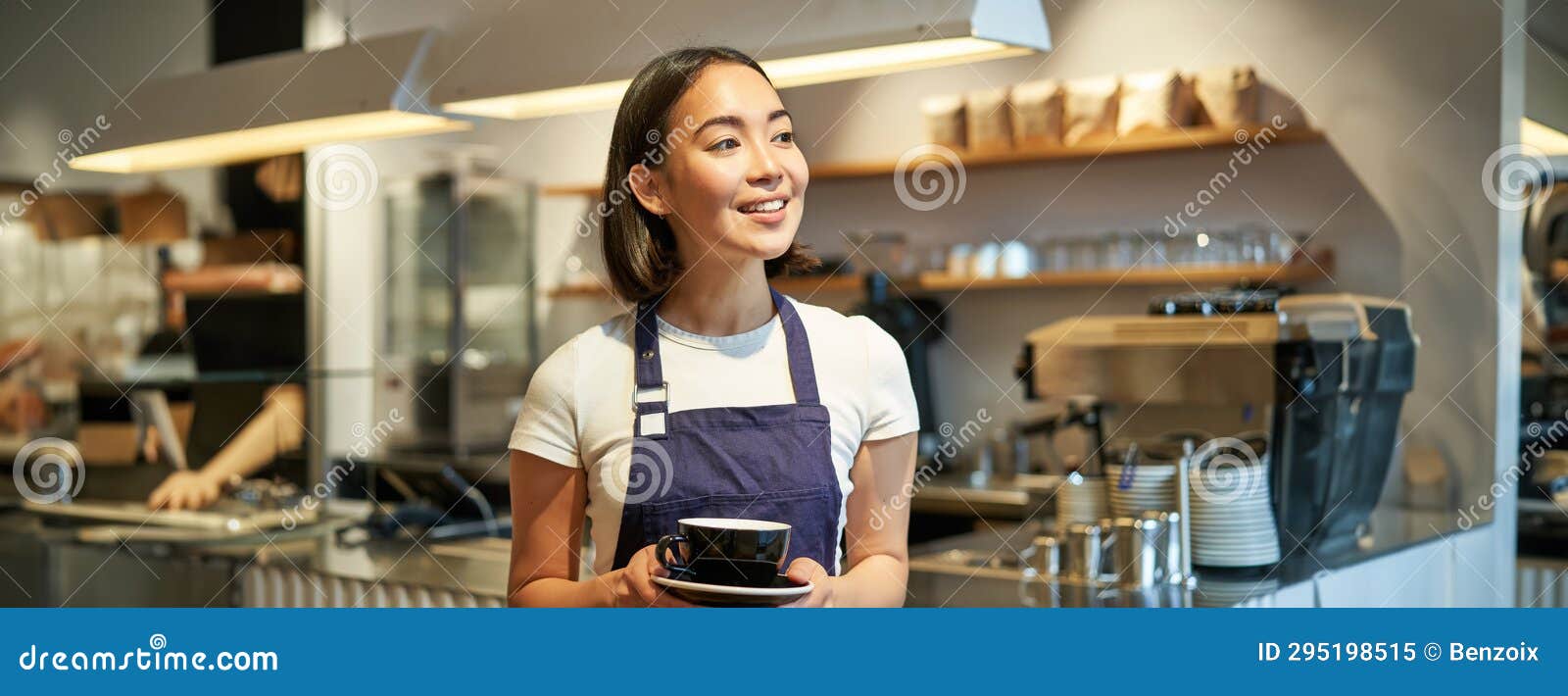 Happy smiling asian barista, girl behind counter, working with POS terminal  and brewing filter kit Stock Photo by benzoix