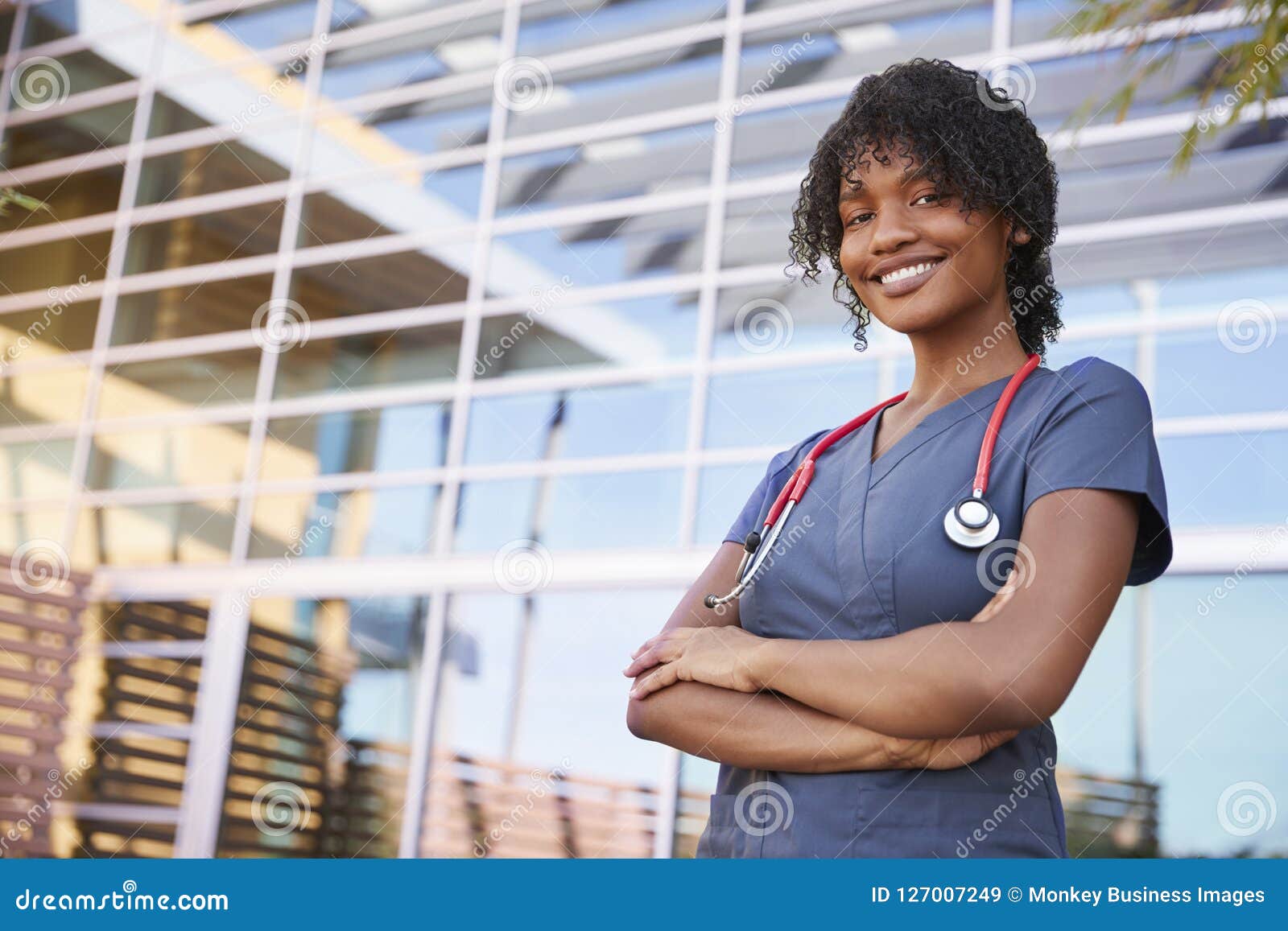 portrait of smiling black female healthcare worker outdoors