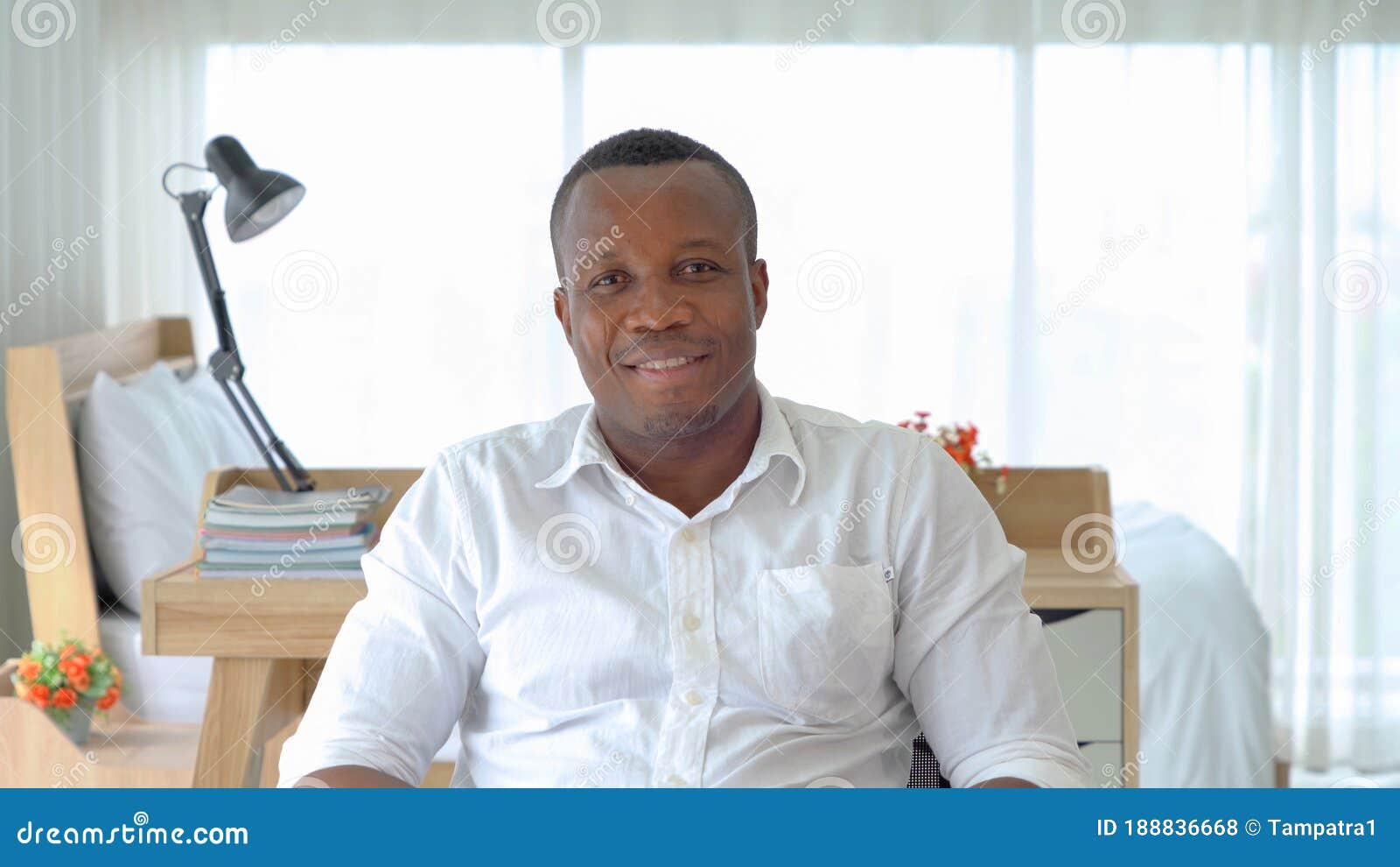 portrait of smiling business black man, african american person working from home and talking to his colleagues in webcam group