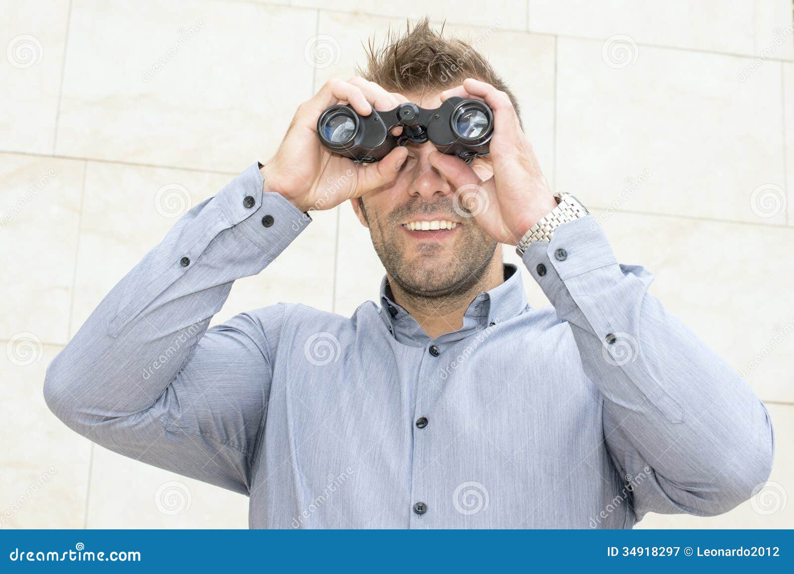 Portrait Of Smiling Businessman Looking Through The Binoculars. Stock