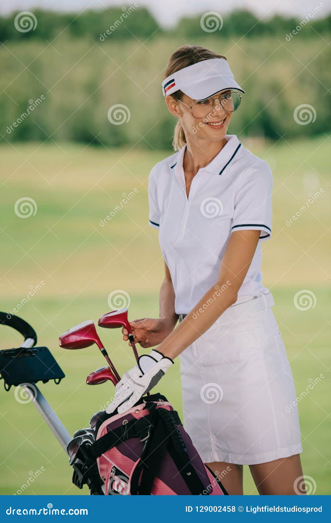 Portrait of Smiling Female Golf Player in Cap with Golf Gear Stock