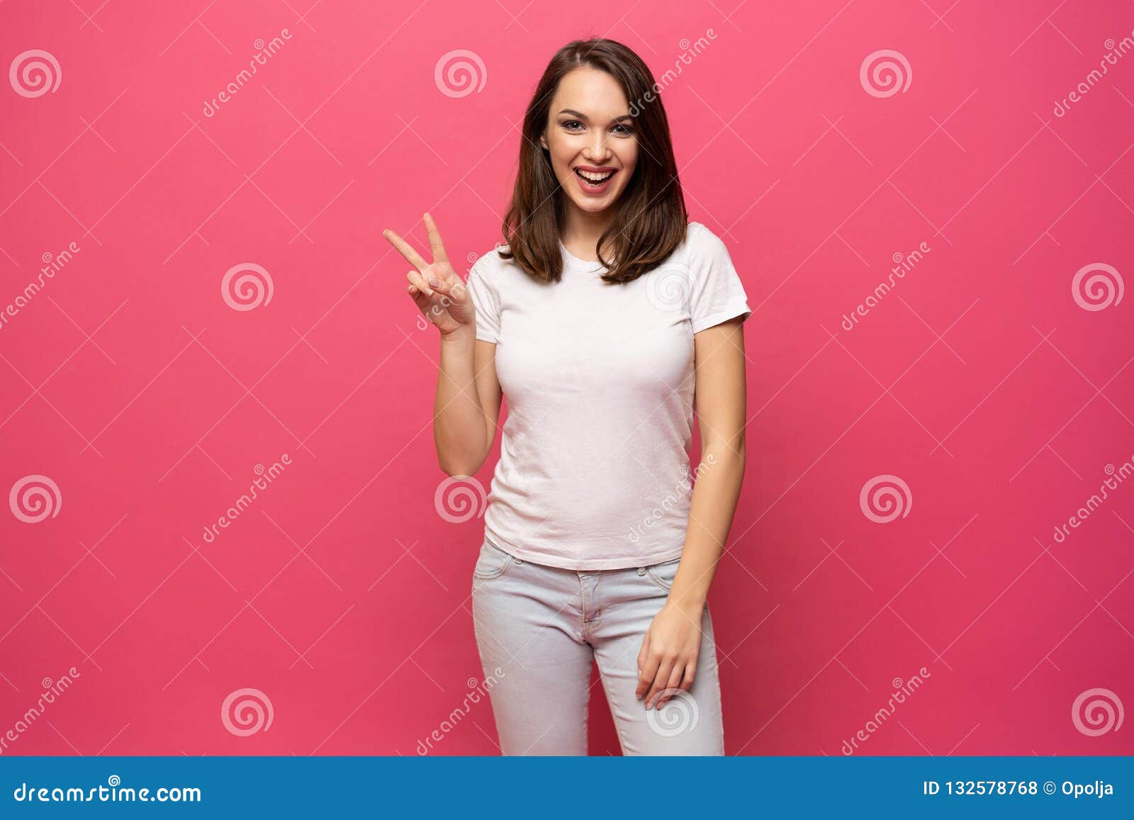 Portrait of a Smiling Happy Woman Showing Victory Sign and Looking at ...