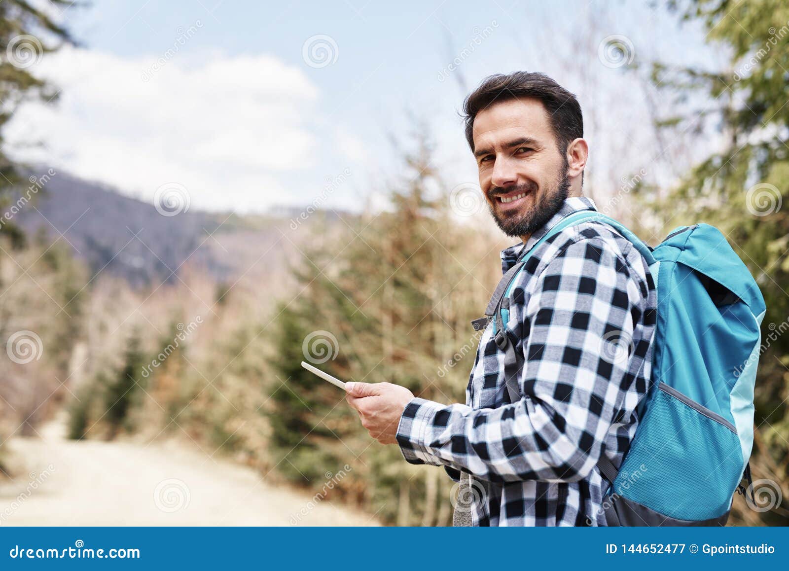 Portrait of Smiling Hiker Using Mobile Phone during Hiking Trip Stock ...