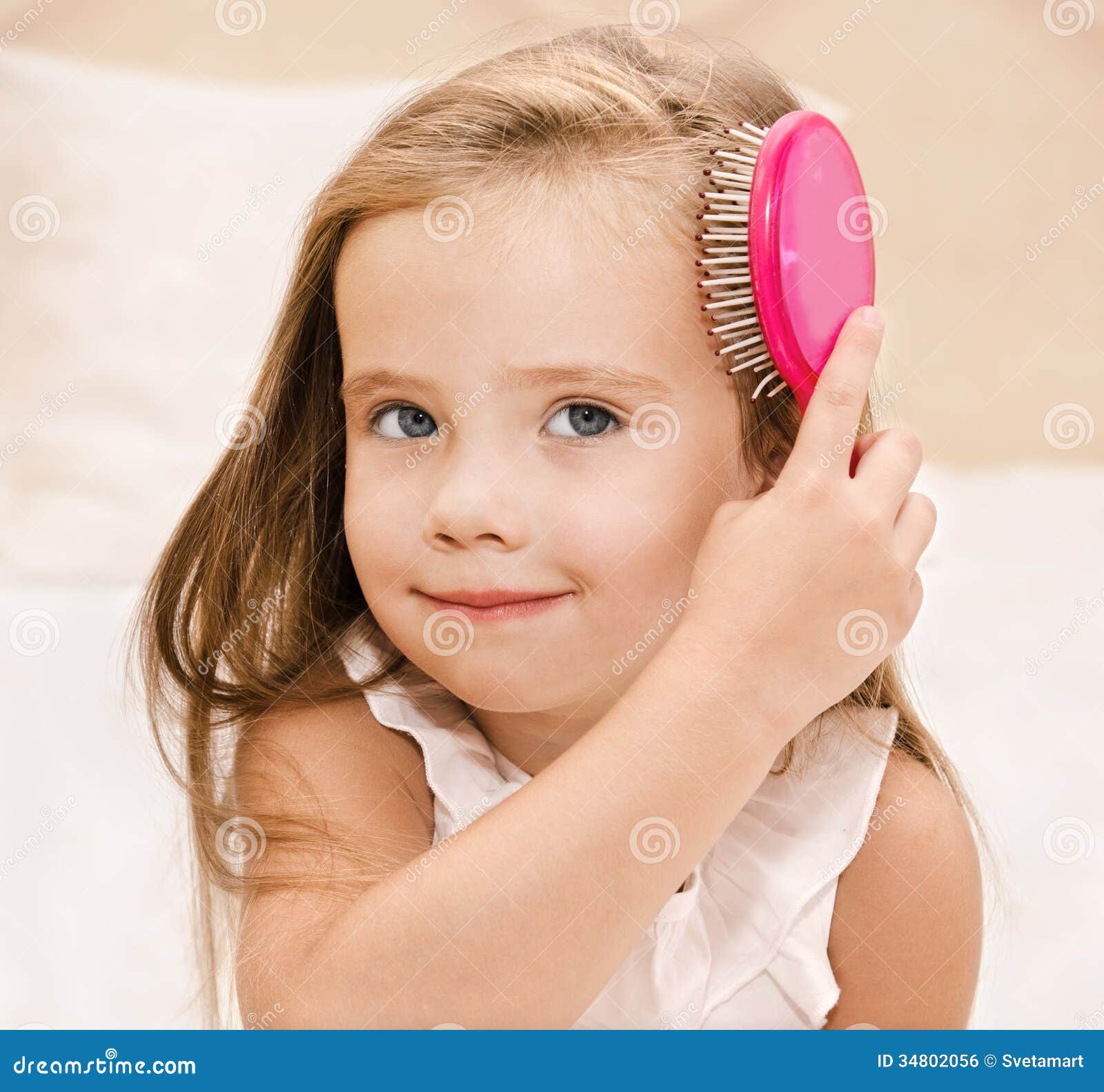 Portrait Of Smiling Little Girl Brushing Her Hair Stock Portrait Of Smiling Little Girl Brushing Her Hair Stock