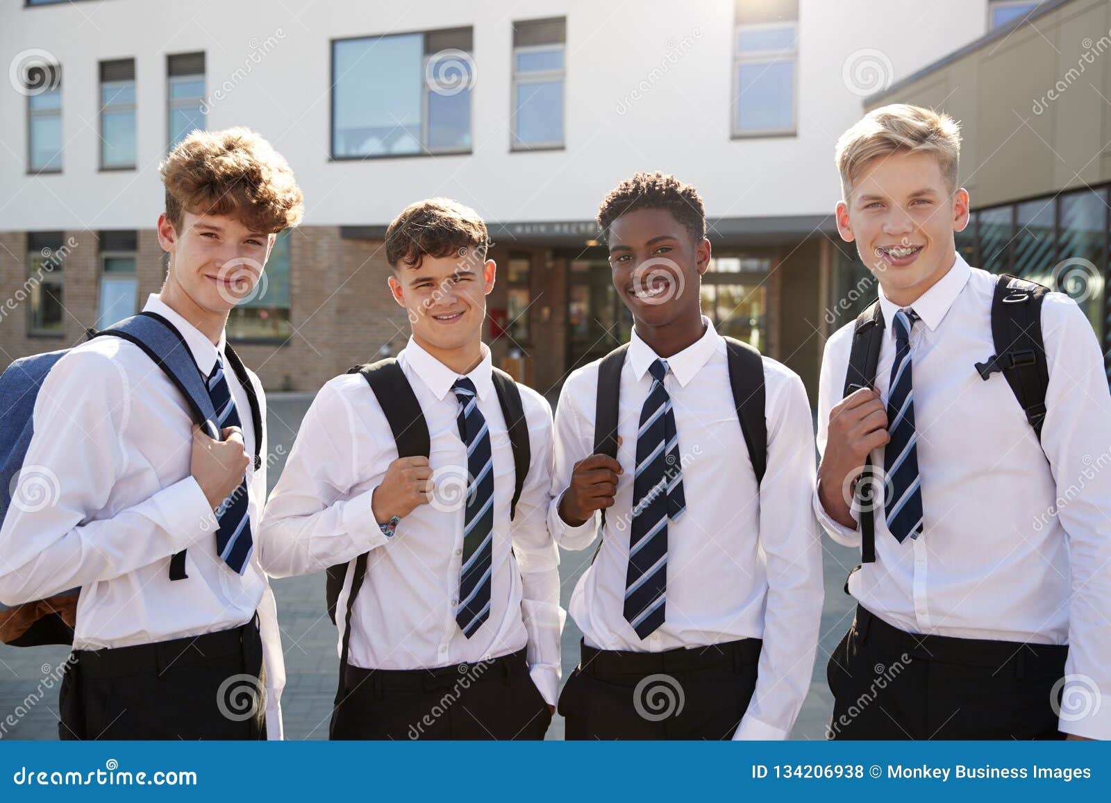 Portrait of Smiling Male High School Students Wearing Uniform Outside ...