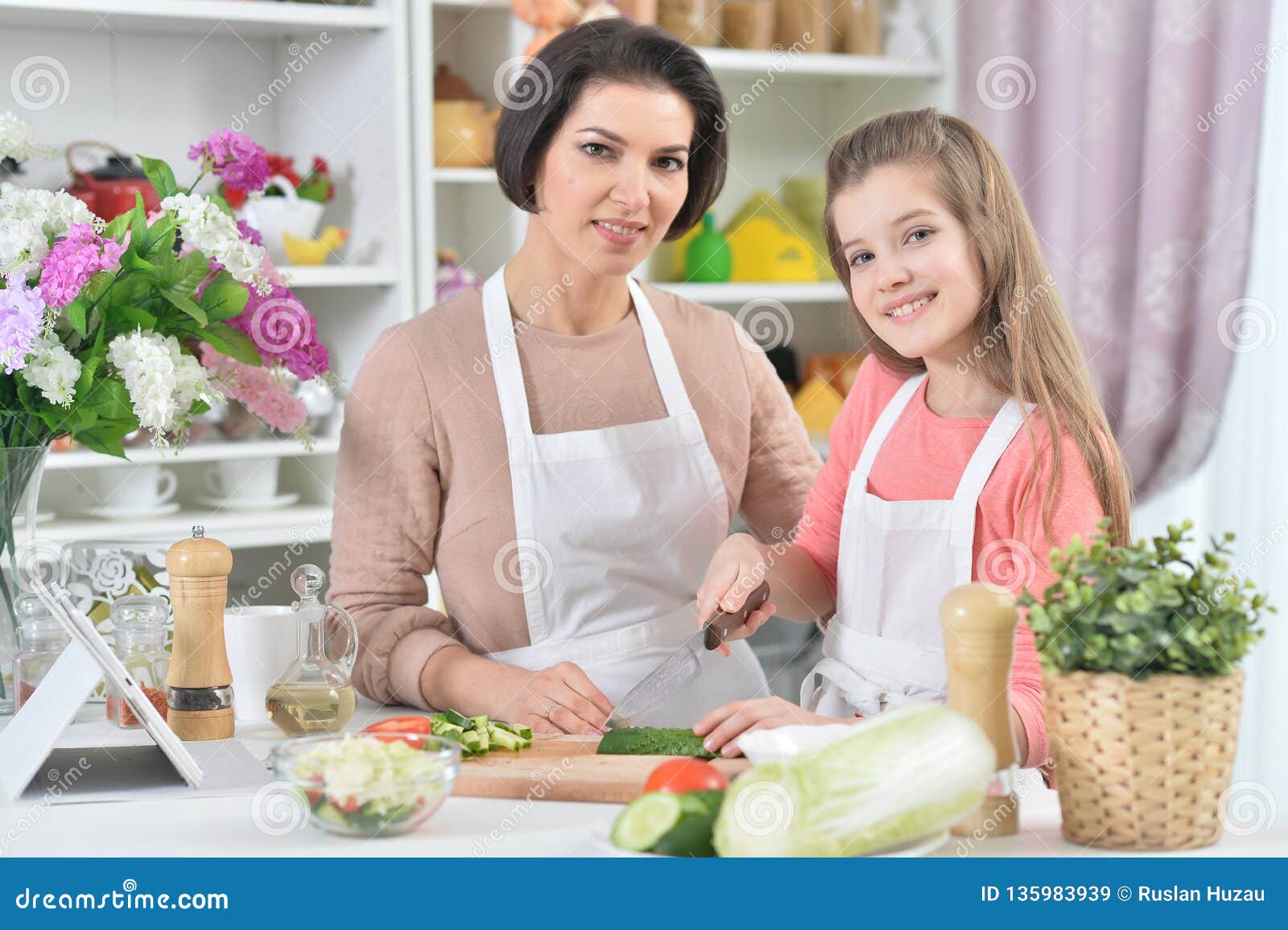 Portrait Of Smiling Mother And Daughter Cooking Together At Kitchen Stock Image Image Of Girl 