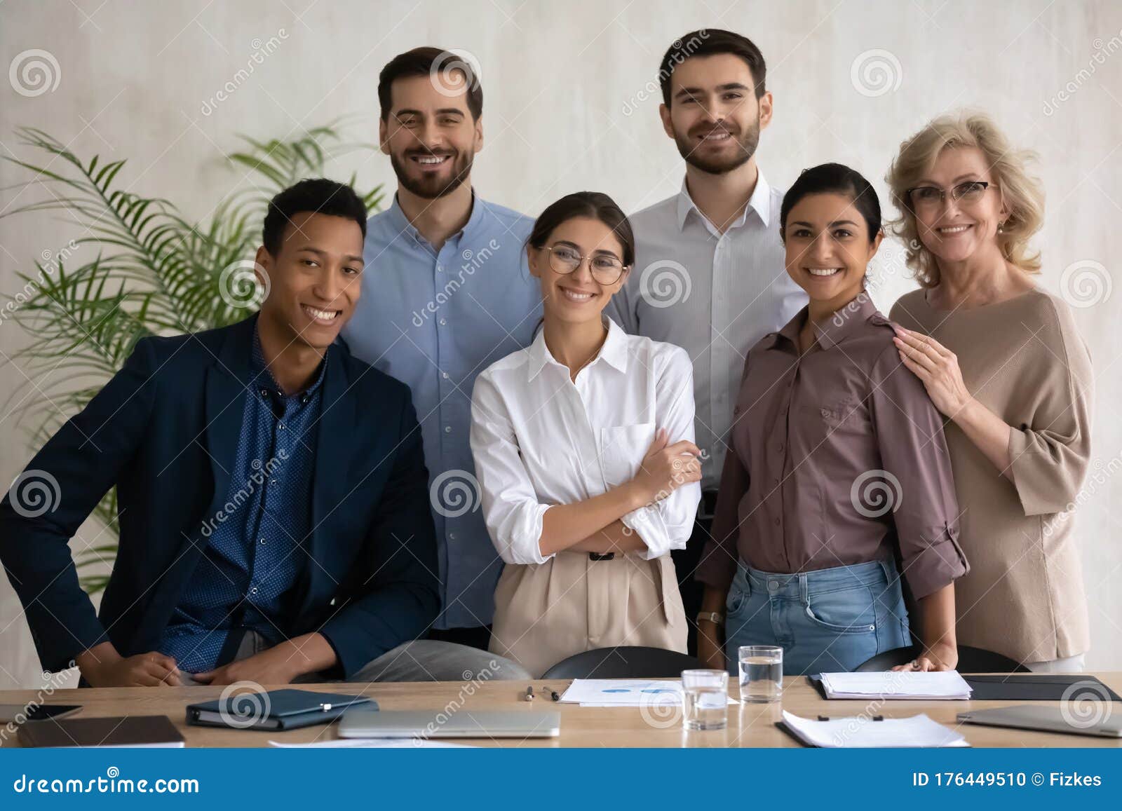 portrait of happy diverse businesspeople posing at workplace together