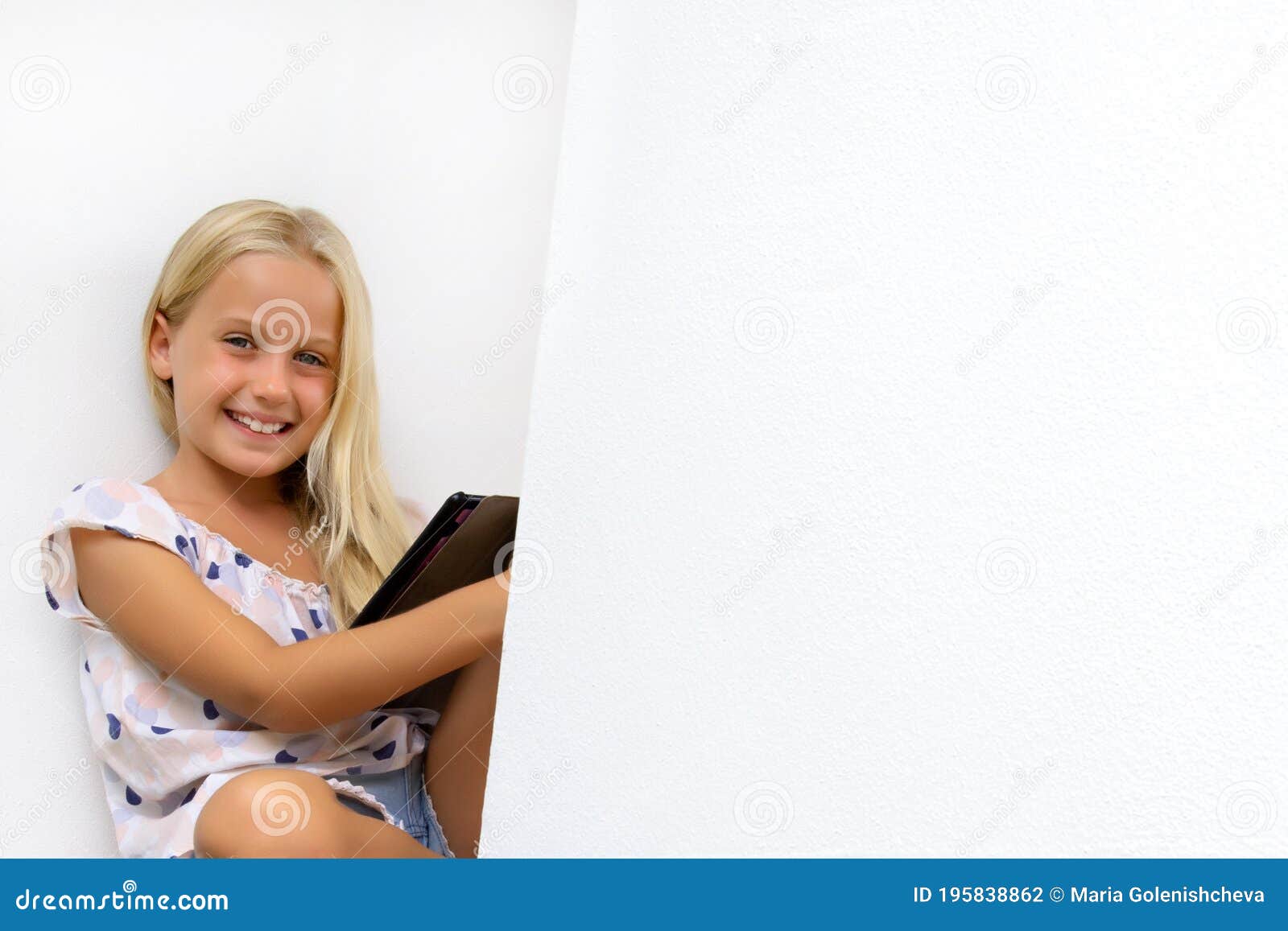 portrait of smiling pretty blond schoolgirl with tablet, attractive smart school kid studying homework in the garden, lifestyle,