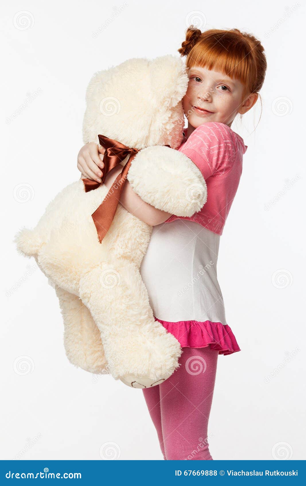 Portrait Of A Smiling Red-haired Girl In A Pink Shirt Hugging Th Stock ...