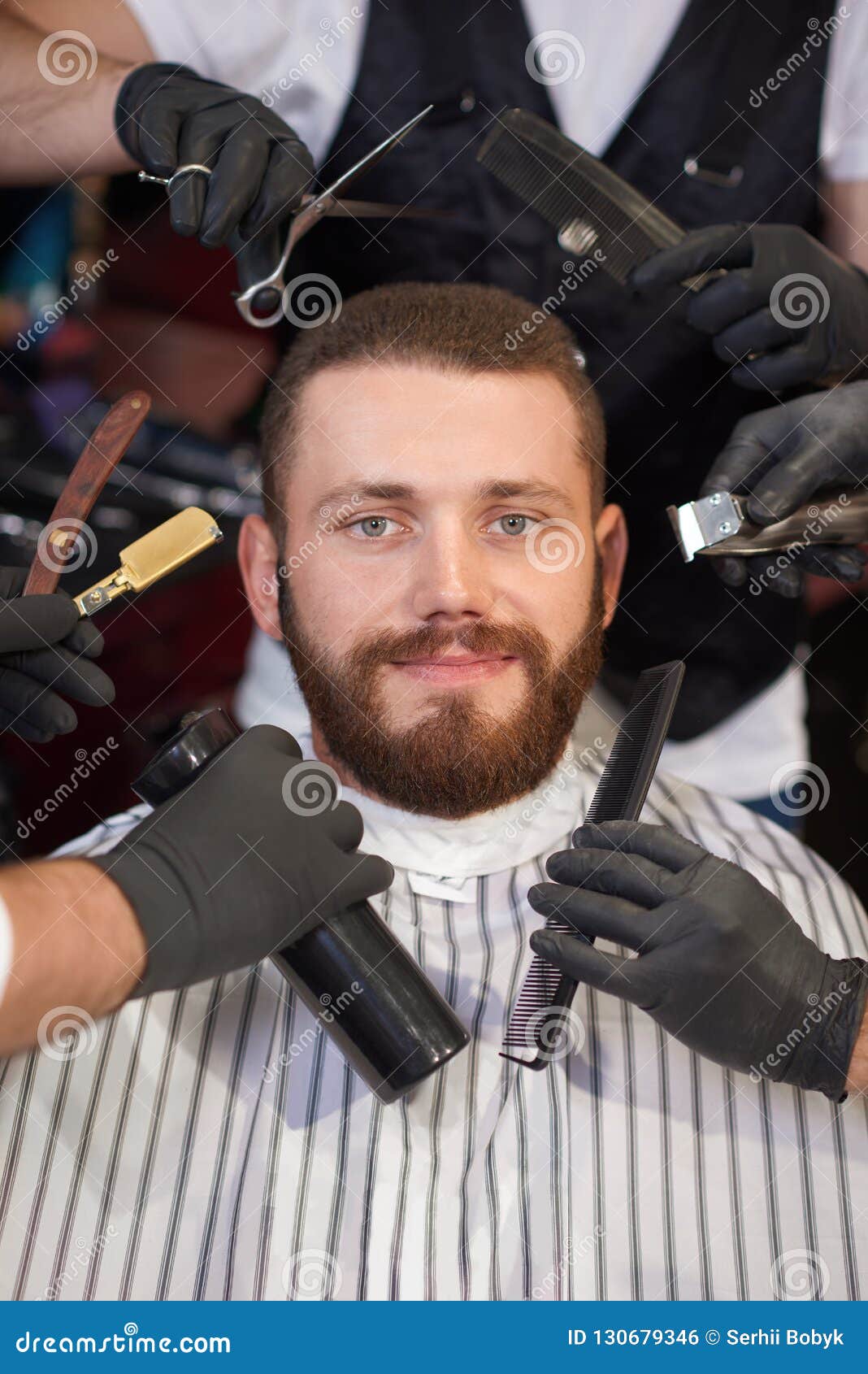 Portrait Of Male Client Getting Hairstyling In Barbershop Stock