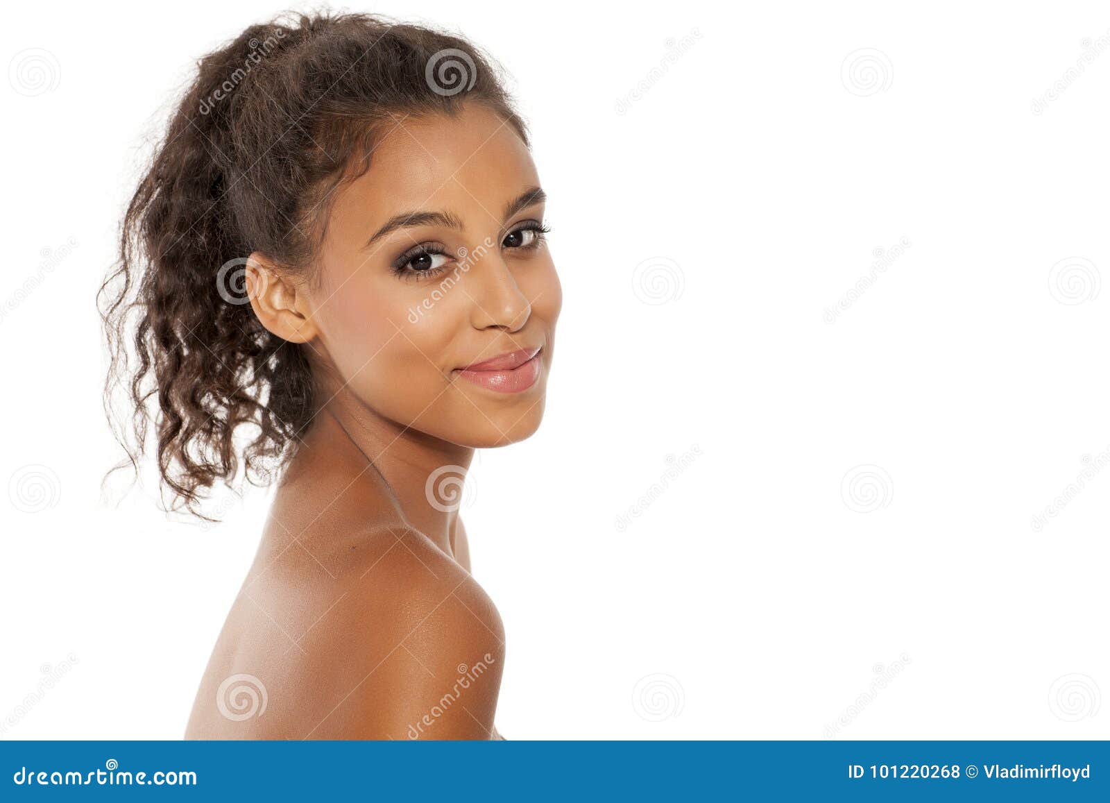 Smiling woman. Portrait of a smiling young dark-skinned woman with naked shoulders posing on a white background