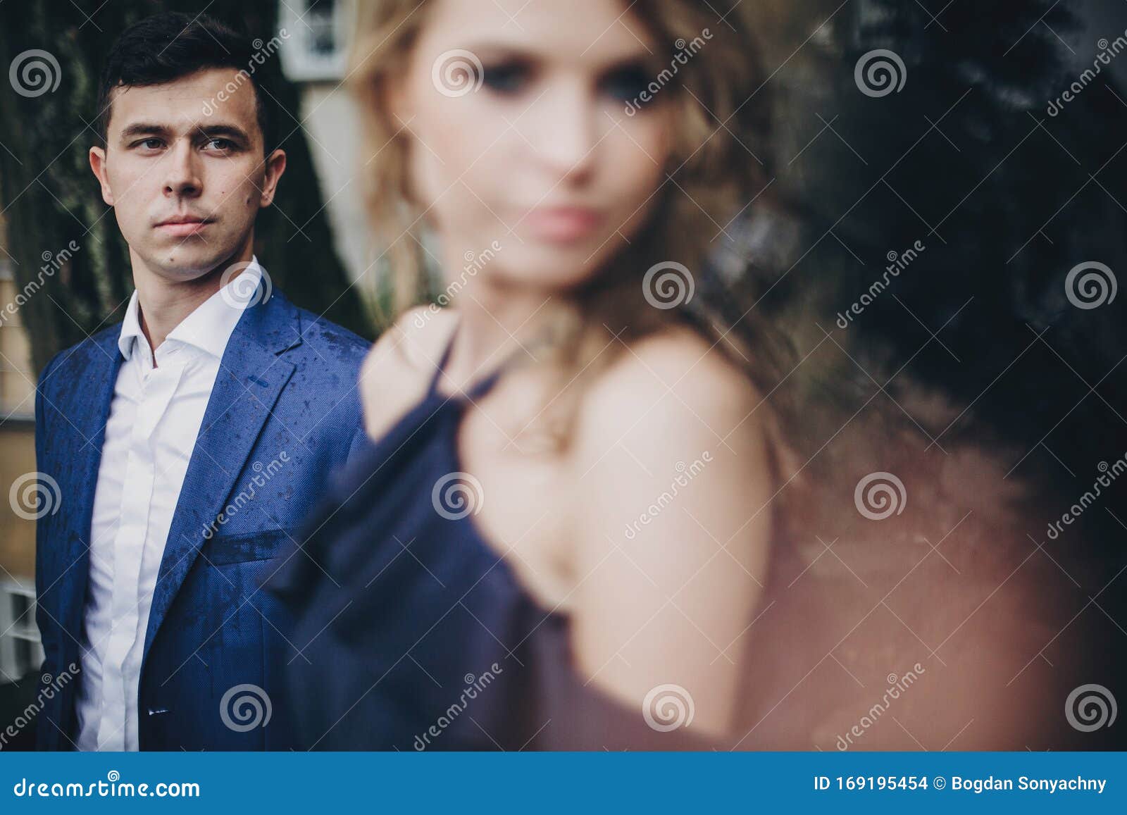 Portrait Of Stylish Couple Embracing In Rainy European City Street Sensual Romantic Moment