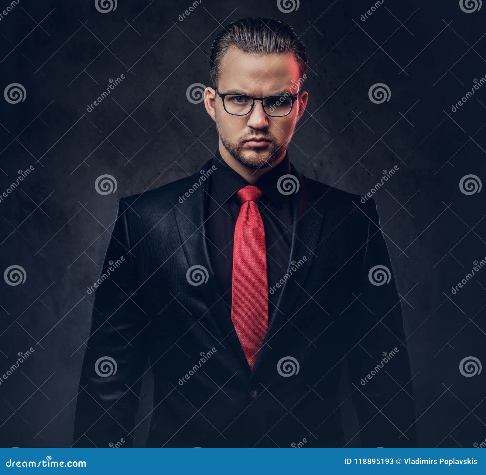 happy relaxed businessman wearing a navy suit and a red tie, walking with  hands in pockets and smiling while standing on white background, full body  p Stock Photo - Alamy