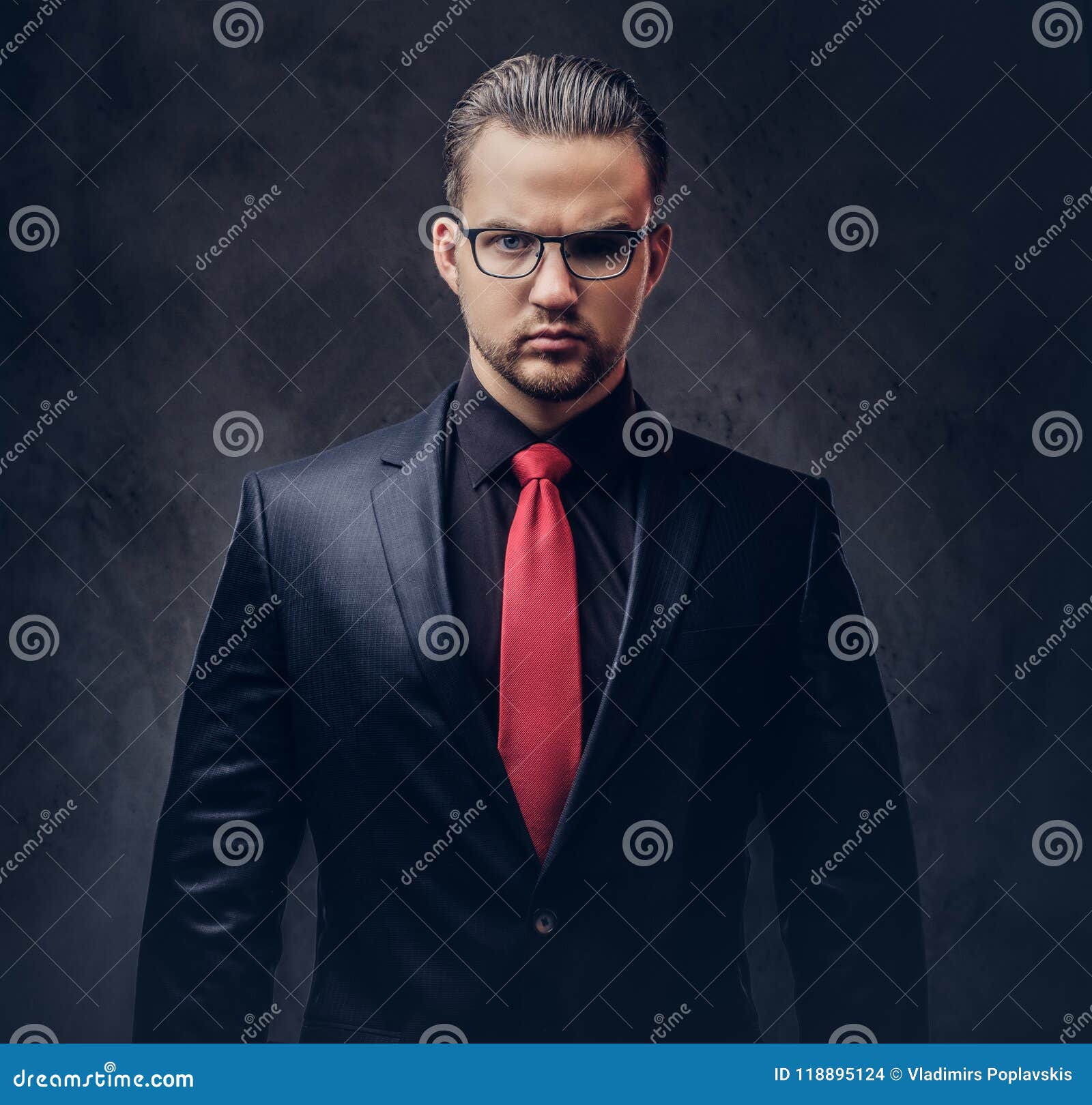 Portrait of a Stylish Male in a Black Suit and Red Tie. Isolated on a ...