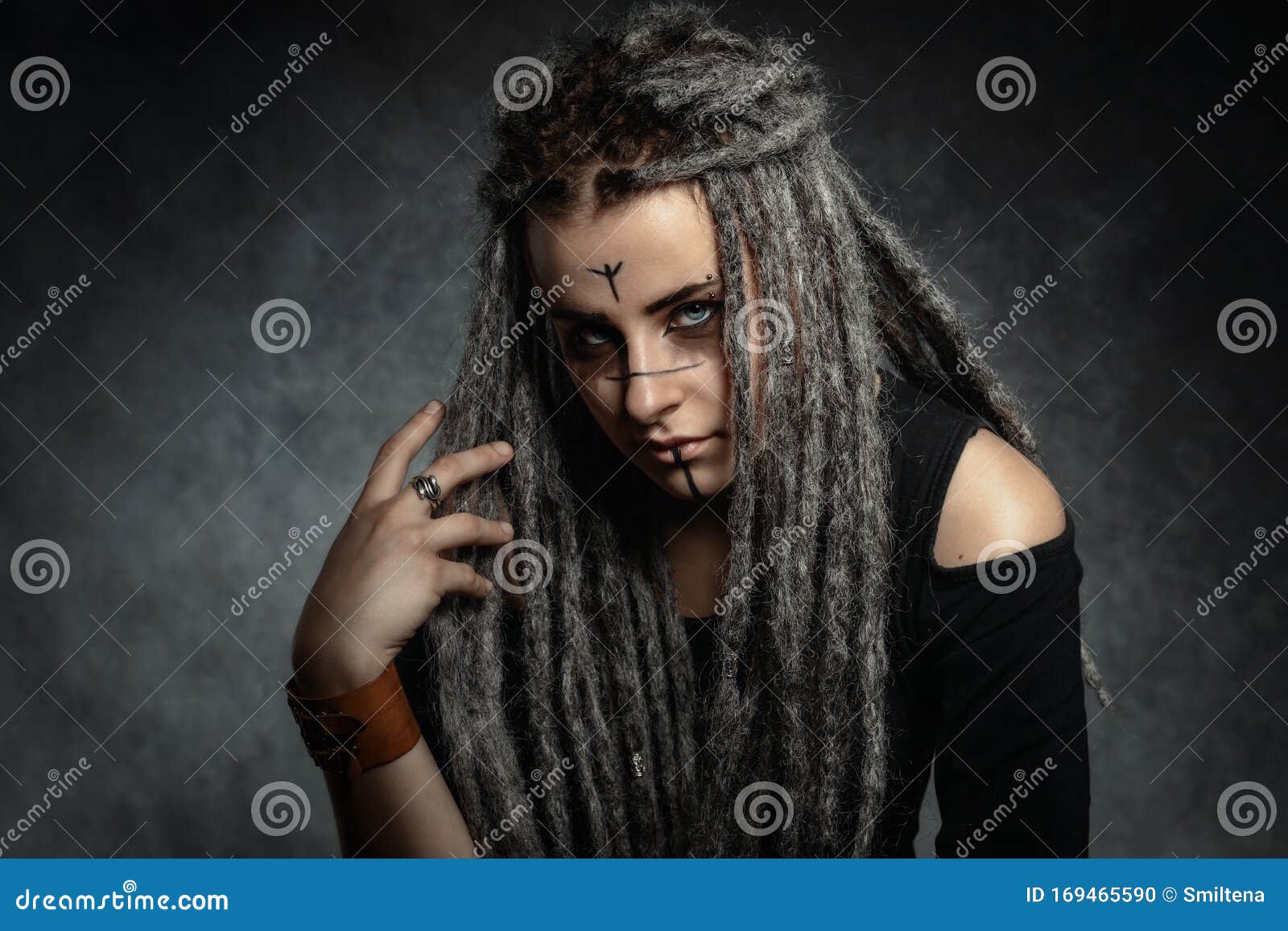 Portrait Of A Young Woman With Dreadlocks Against Dark Background Stock ...