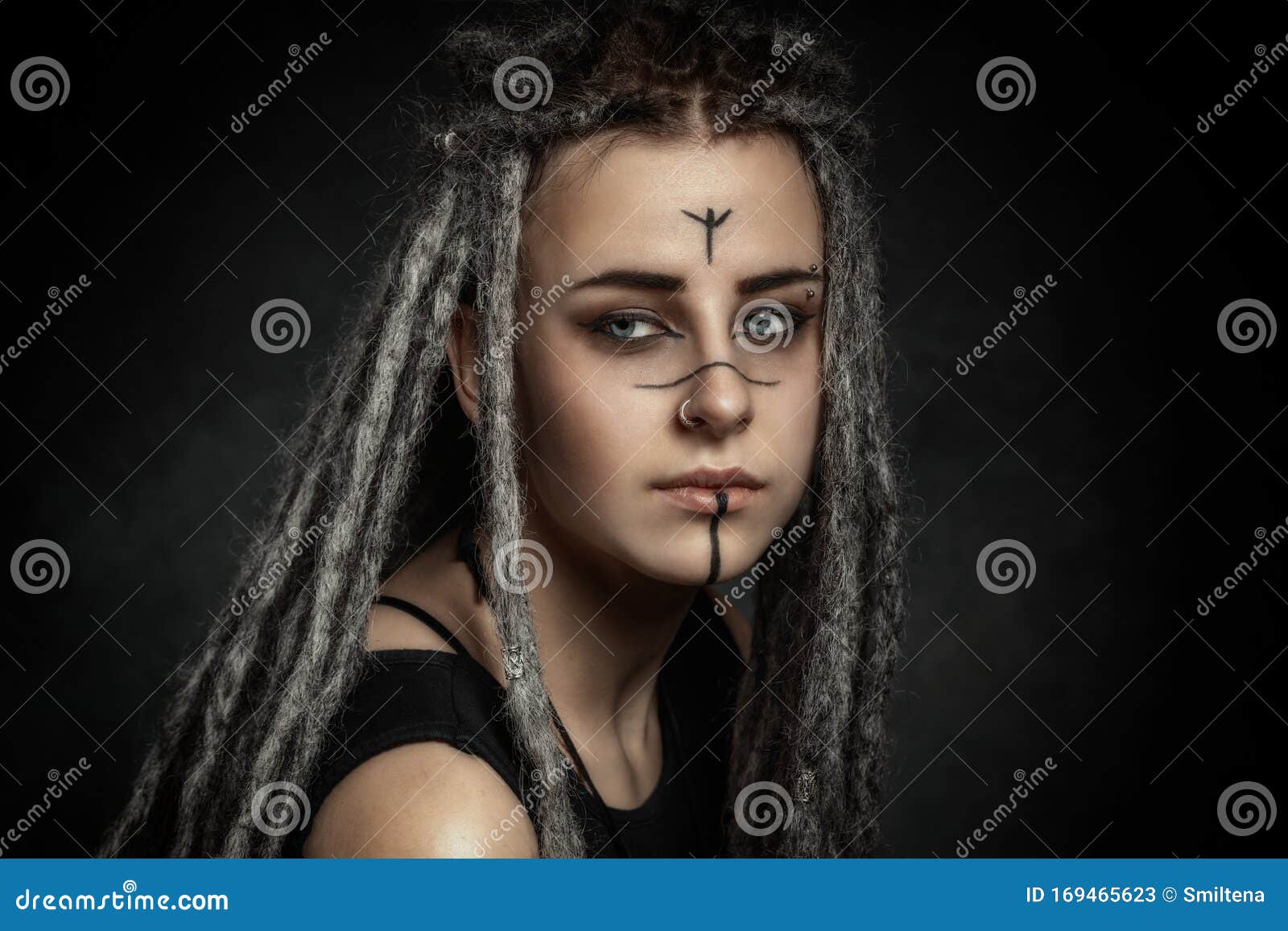 Portrait Of A Young Woman With Dreadlocks Against Dark Background Stock ...