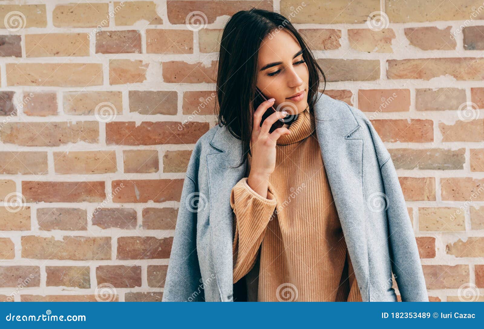 Woman against brick wall stock photo. Image of stood 