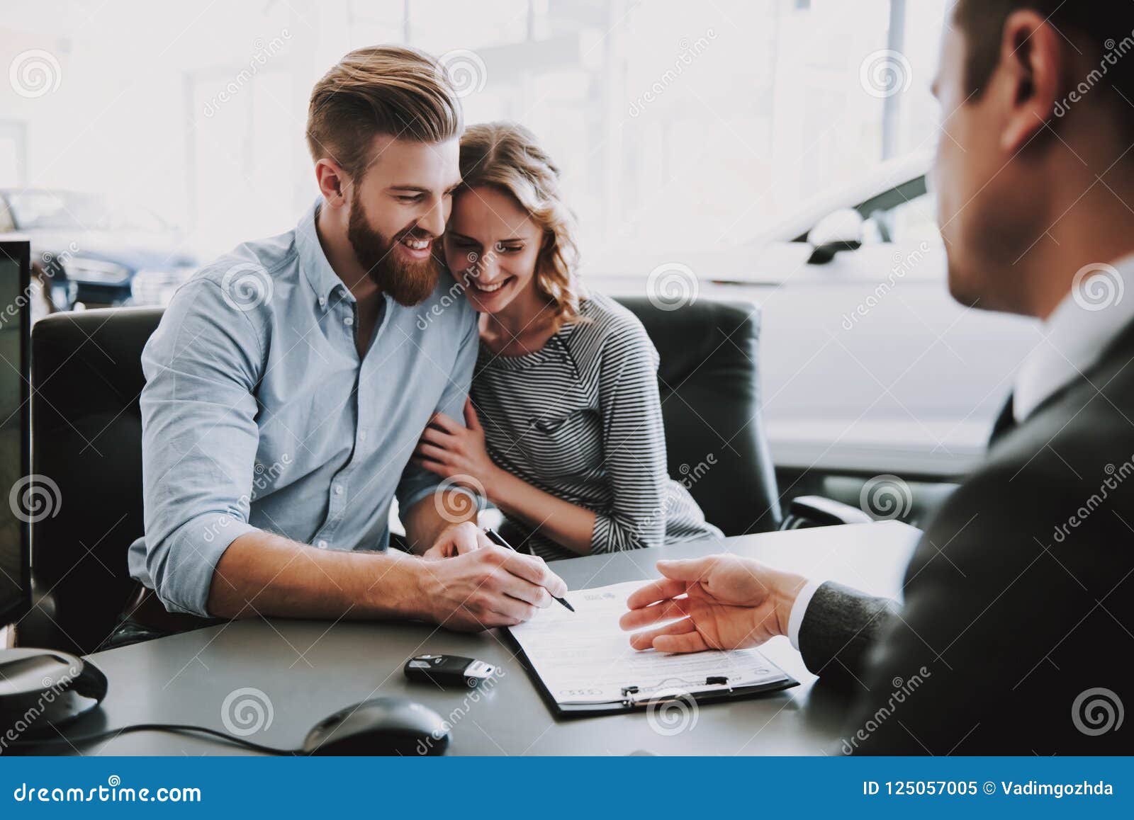 portrait of successful young couple buying car