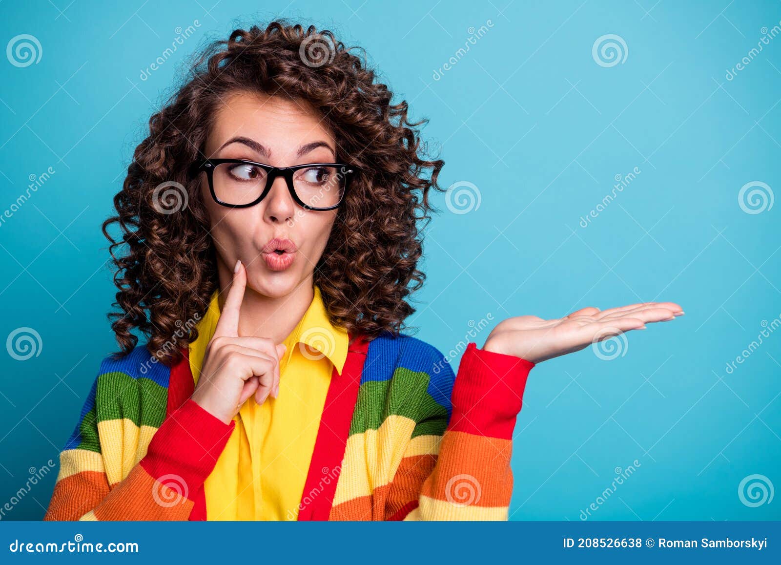 portrait of surprised shocked beautiful young woman ads promo reccomend look empty space  over blue color