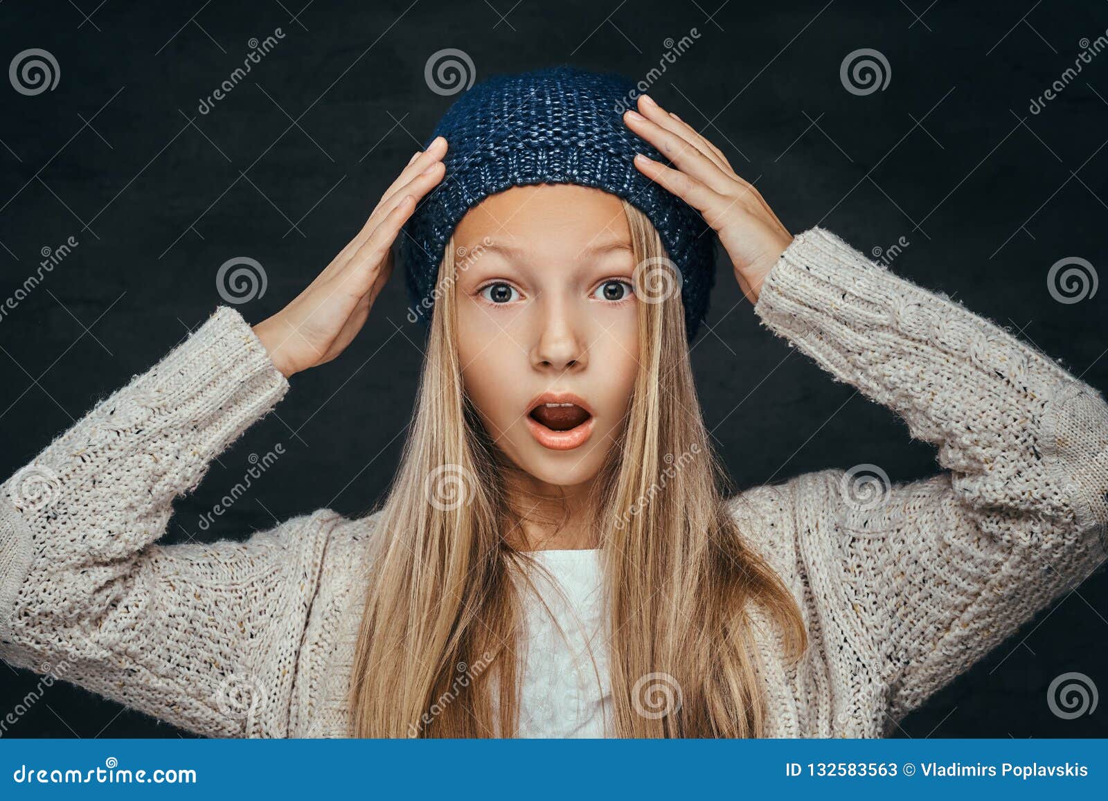 Portrait Of A Surprised Teen Girl With Blonde Hair Weari