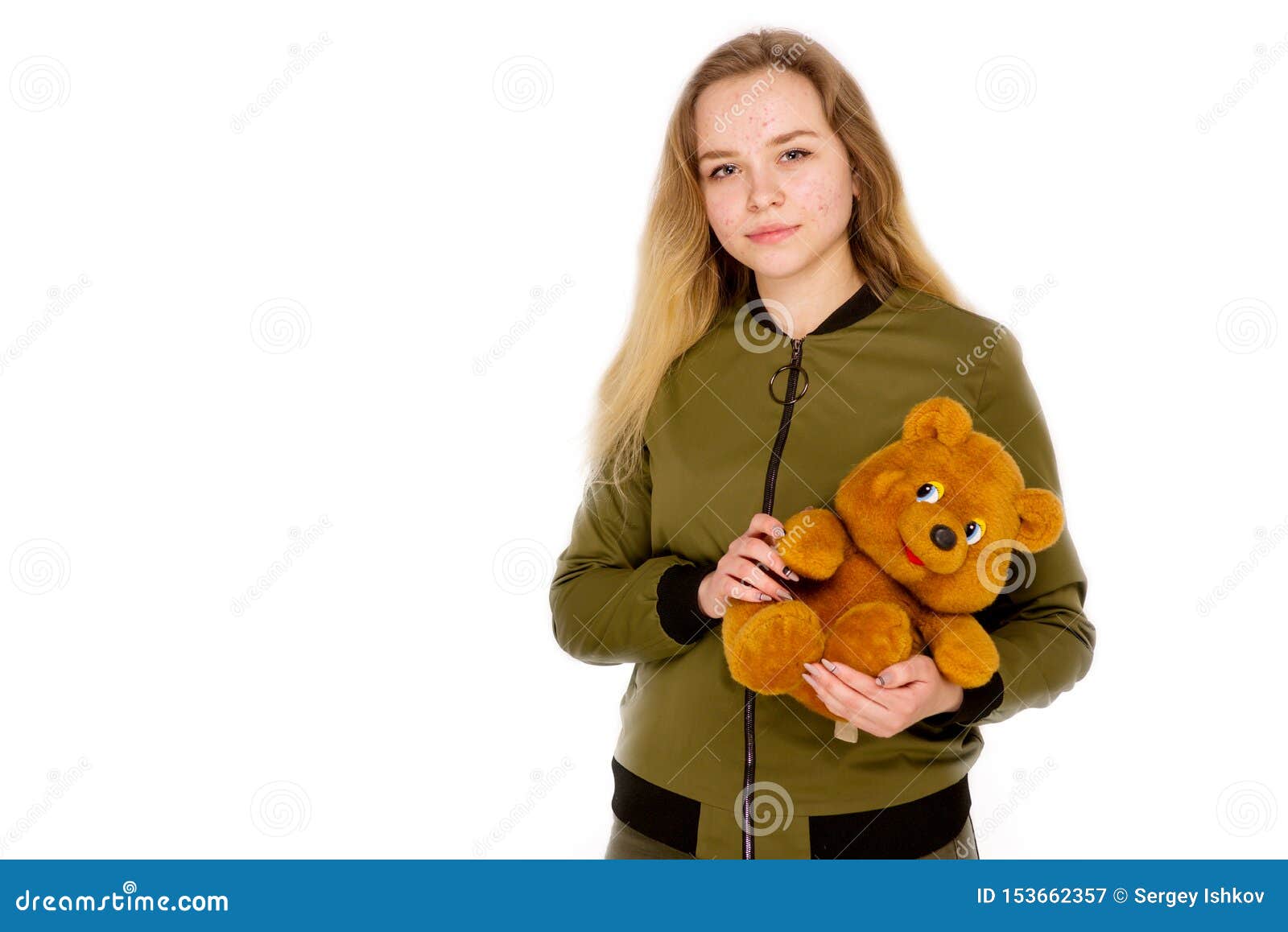 Portrait of a Teenager Teen Girl with a Teddy Bear in Her Hands on a ...