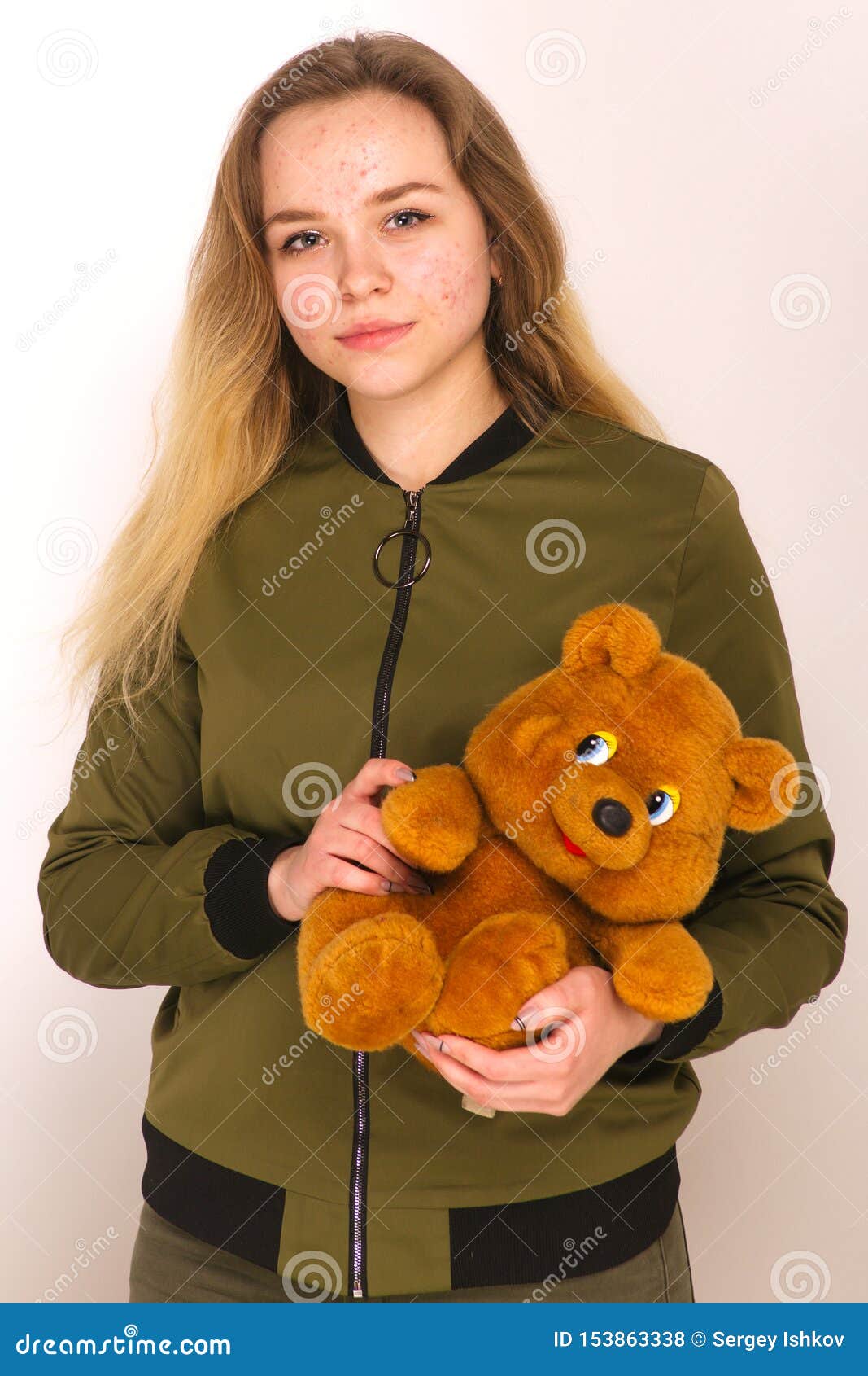 Portrait of a Teenager Teen Girl with a Teddy Bear in Her Hands on a ...