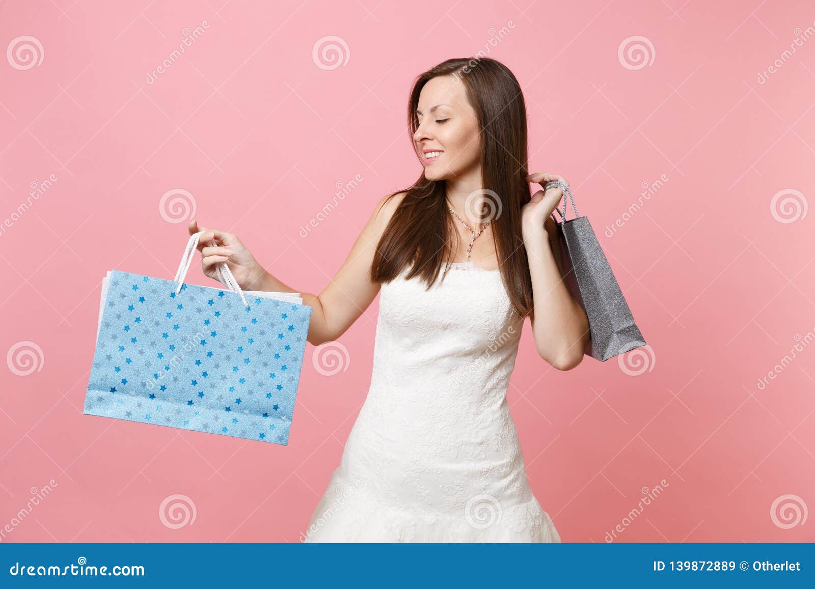 Portrait Of Tender Bride Woman In Wedding Dress Looking On Multi Colored Packages Bags With