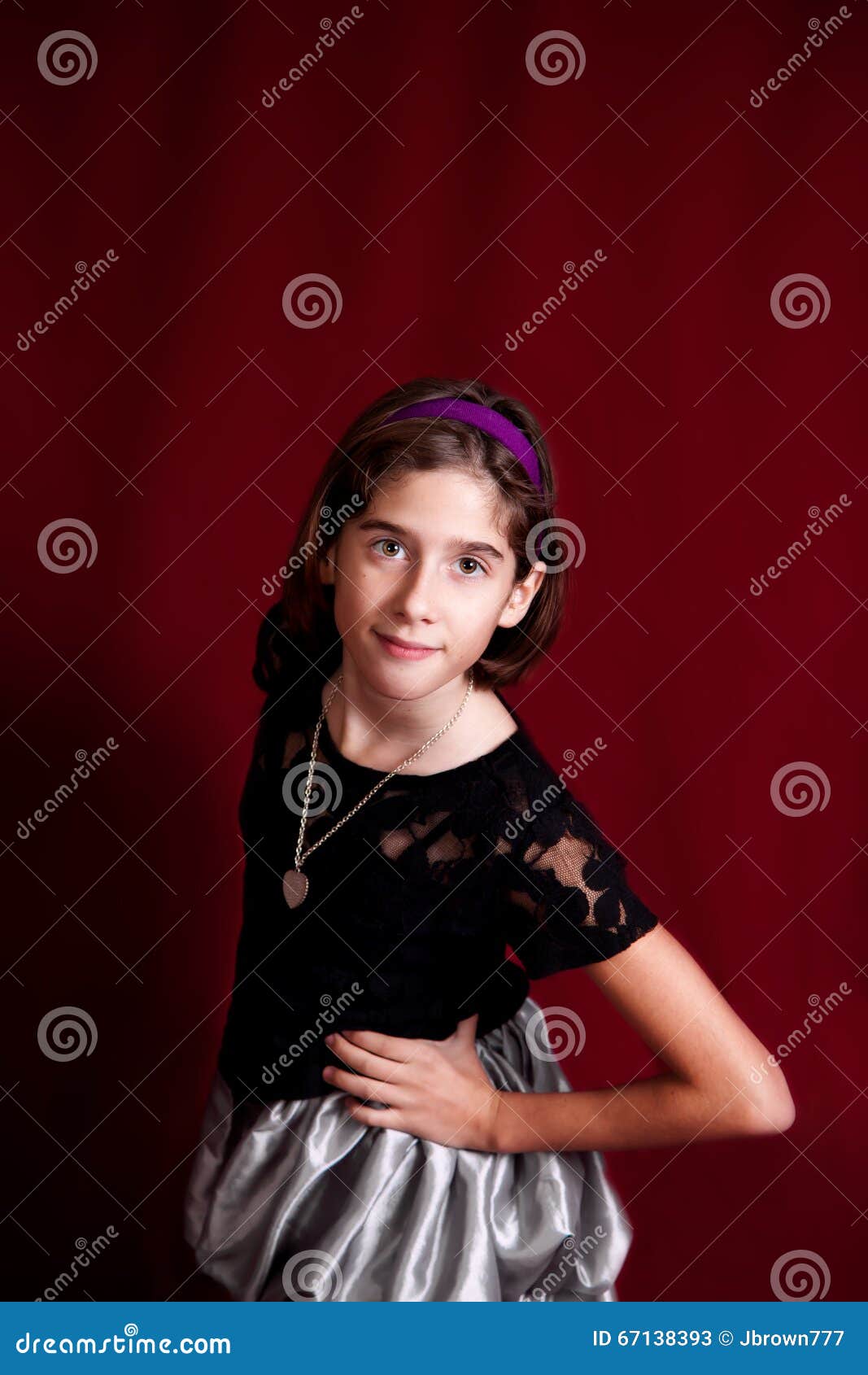 portrait of a tween on a deep red backdrop