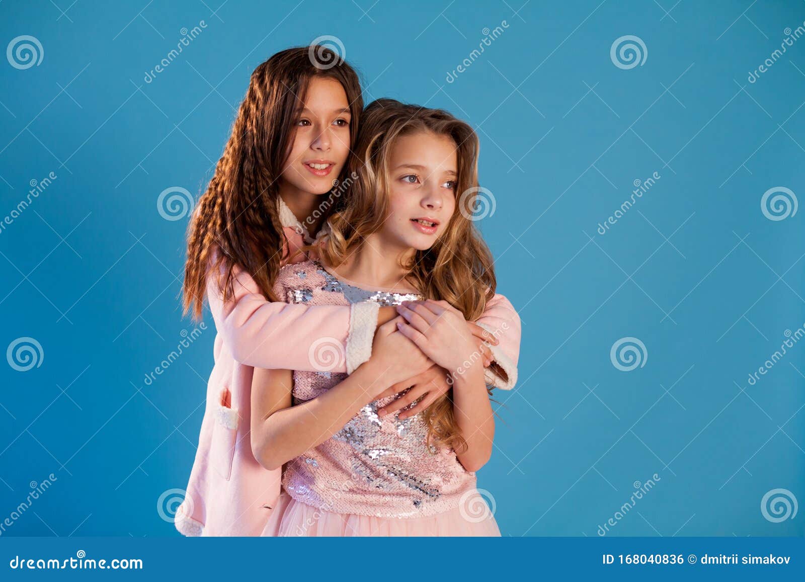 Portrait of Two Beautiful Fashionable Girls in a White Dress and Pink ...
