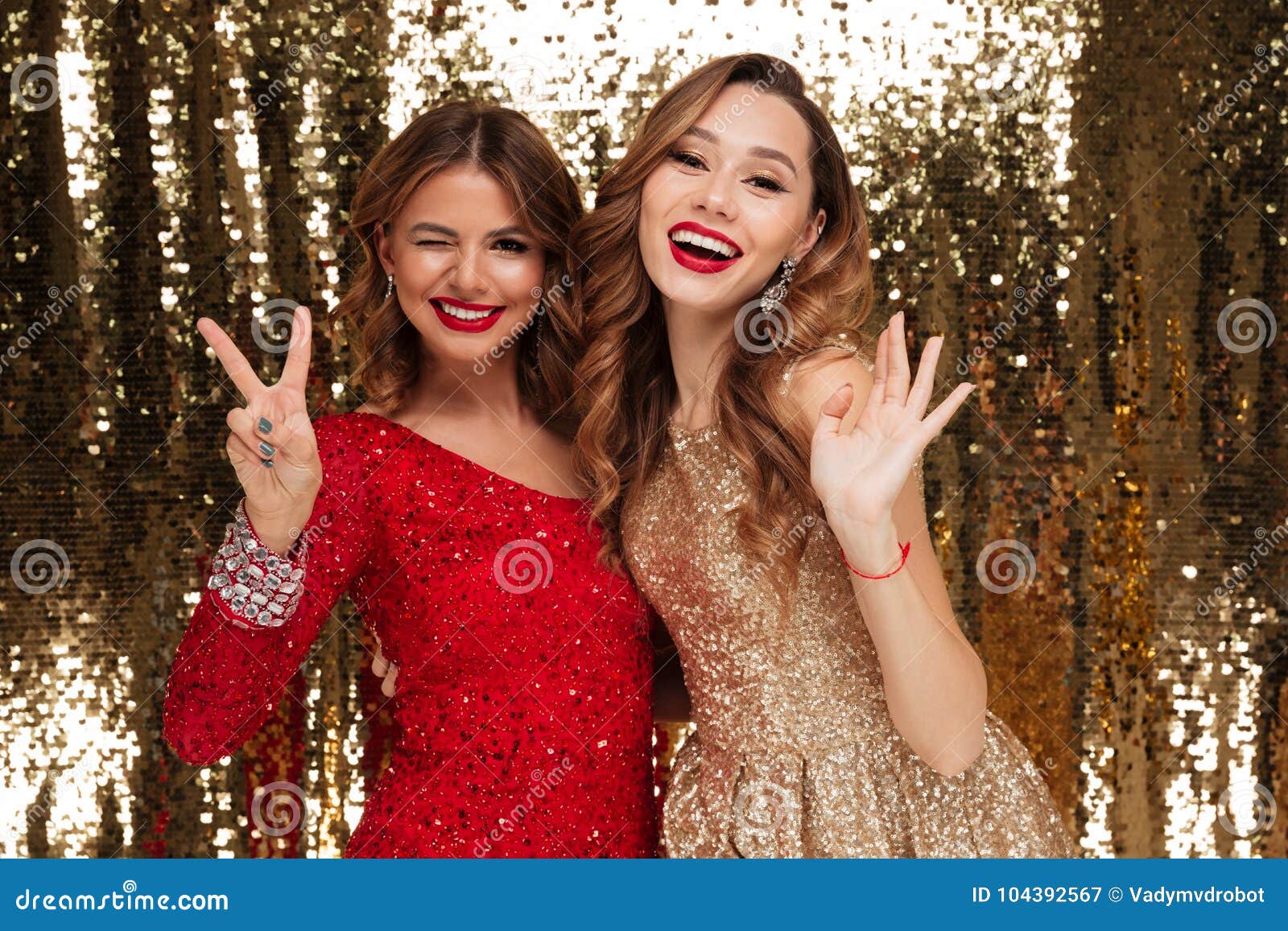 Portrait Of Two Cheerful Smiling Women In Sparkly Dresses Stock Image ...