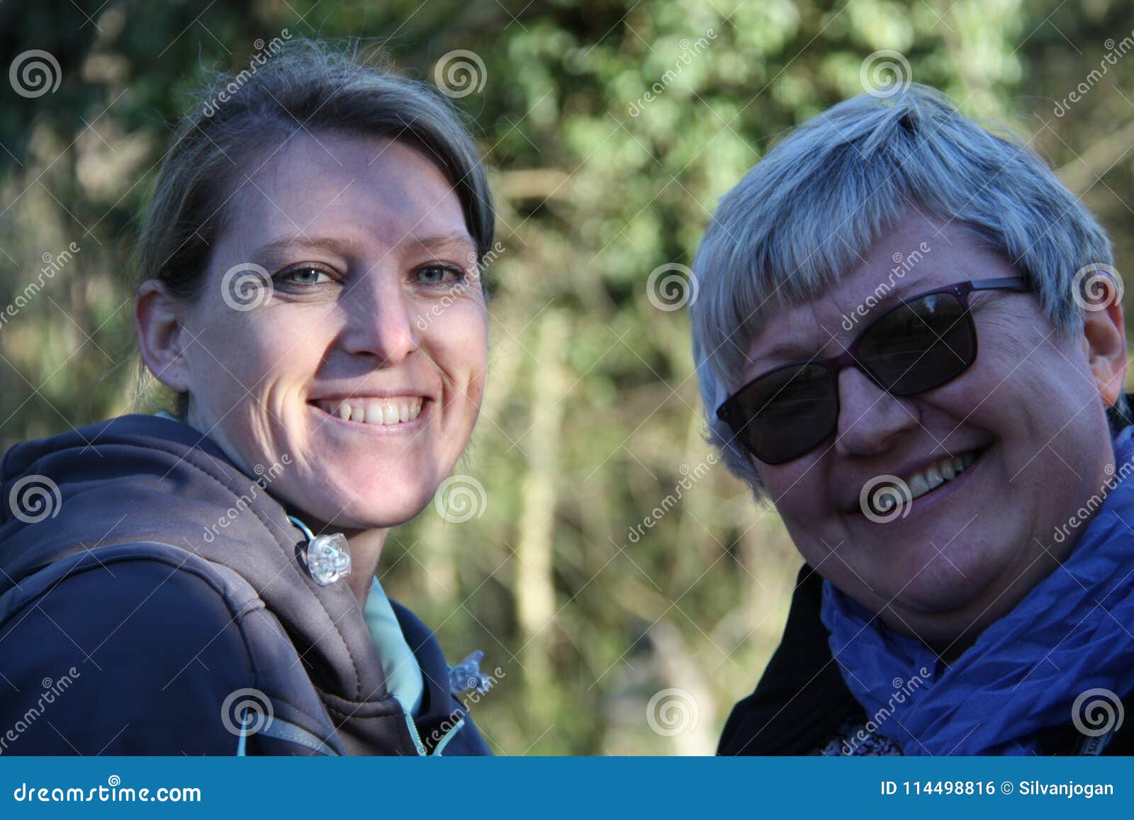 a portrait of two smiling collegue ladies in the nature