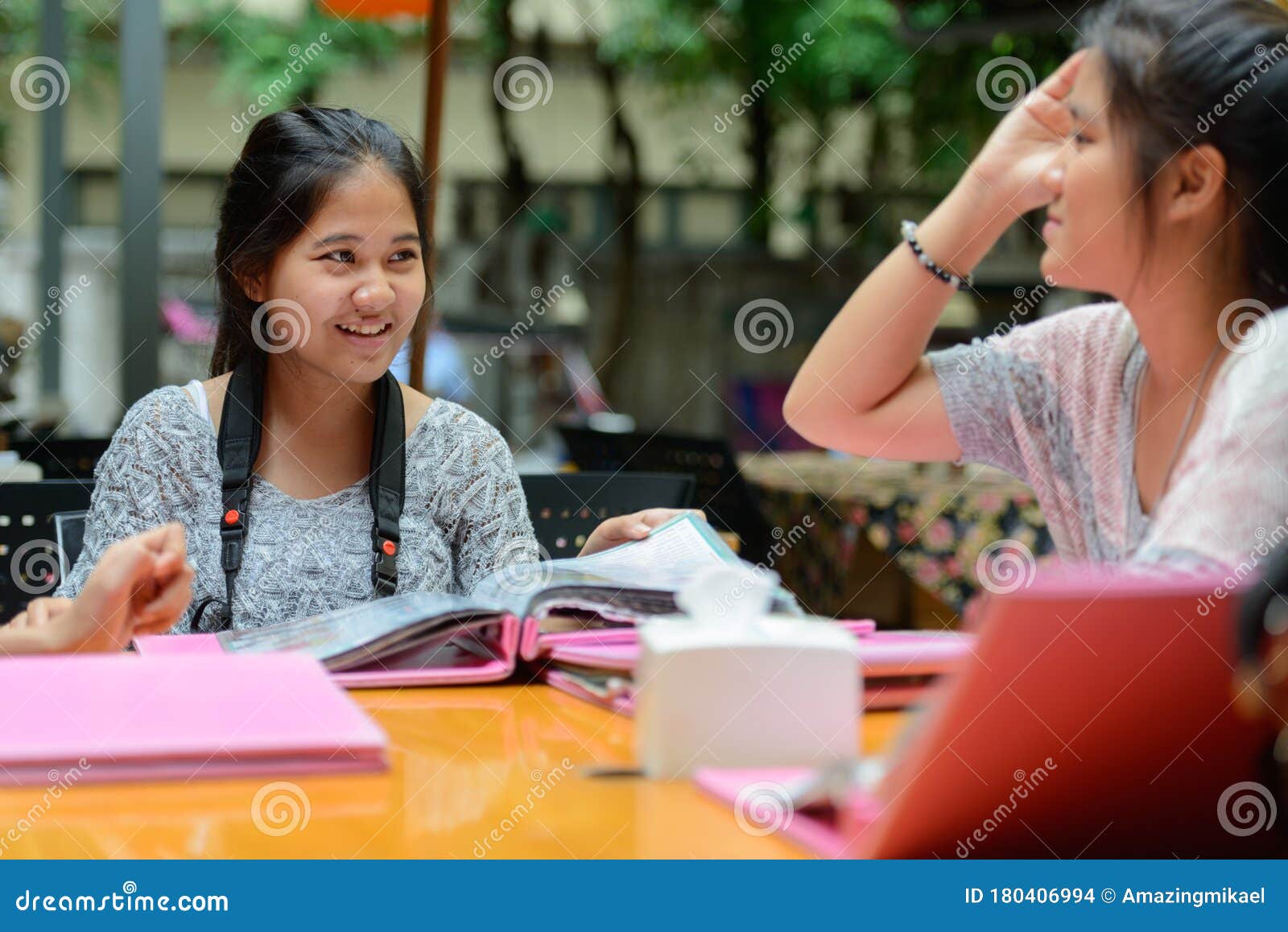 Young Asian Women As Friends Reading Menu at the Coffee Shop Outdoors