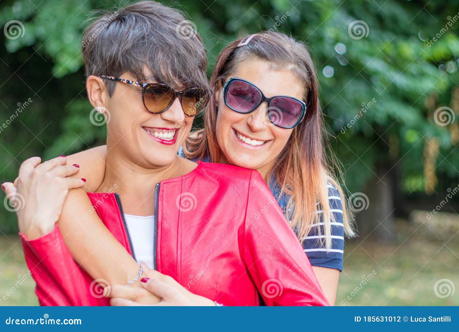 Portrait Of Two Young Beautiful Lesbian Smiling Girls Hug Each Other In