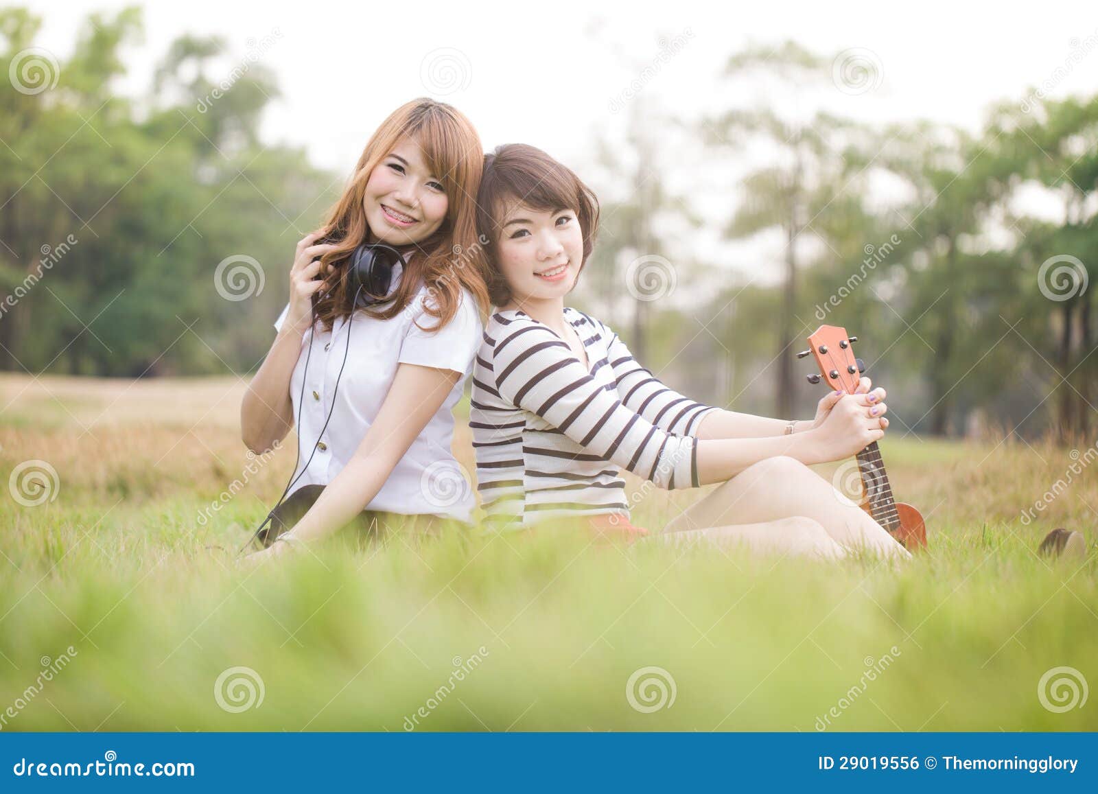 Portrait Two Young Women on the Nature of the Ukulele Stock Photo