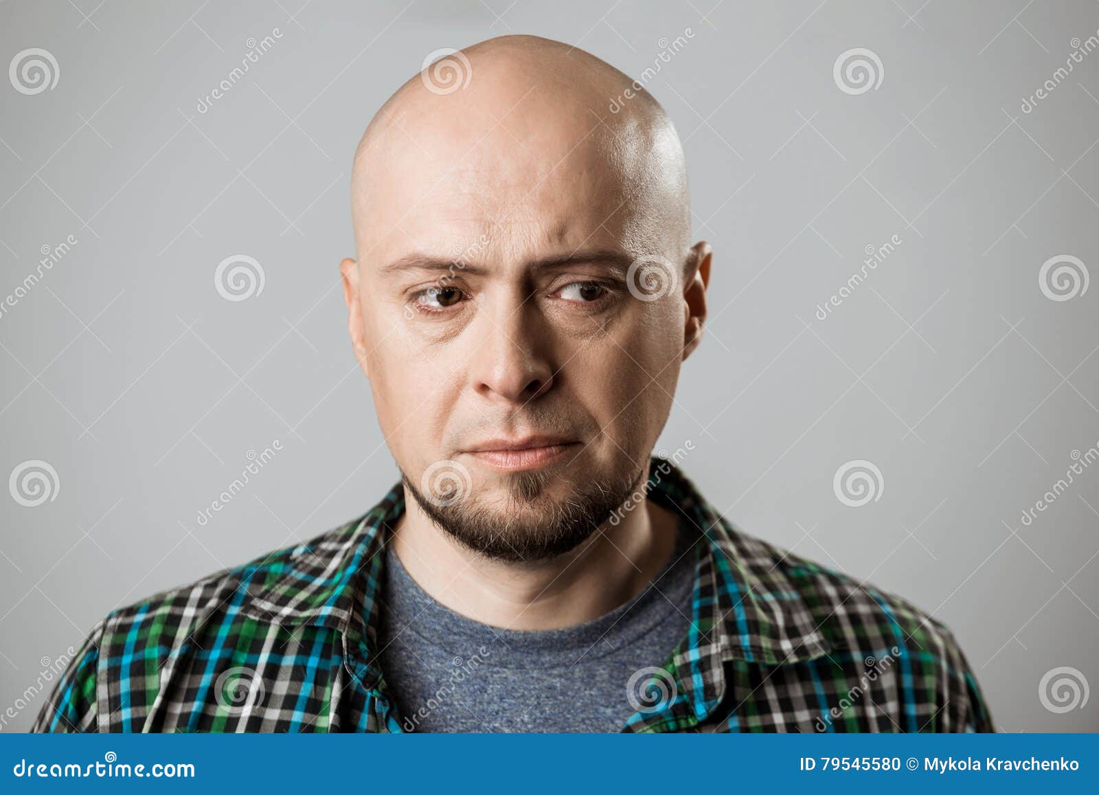 Portrait Of Upset Handsome Man Thinking Over Beige Background. Stock ...