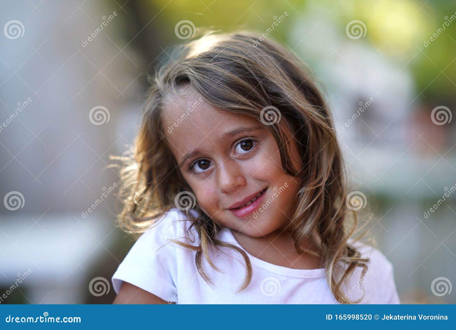 Portrait of a Very Cute 4 Year Old Girl Who Smiles and Looks ...