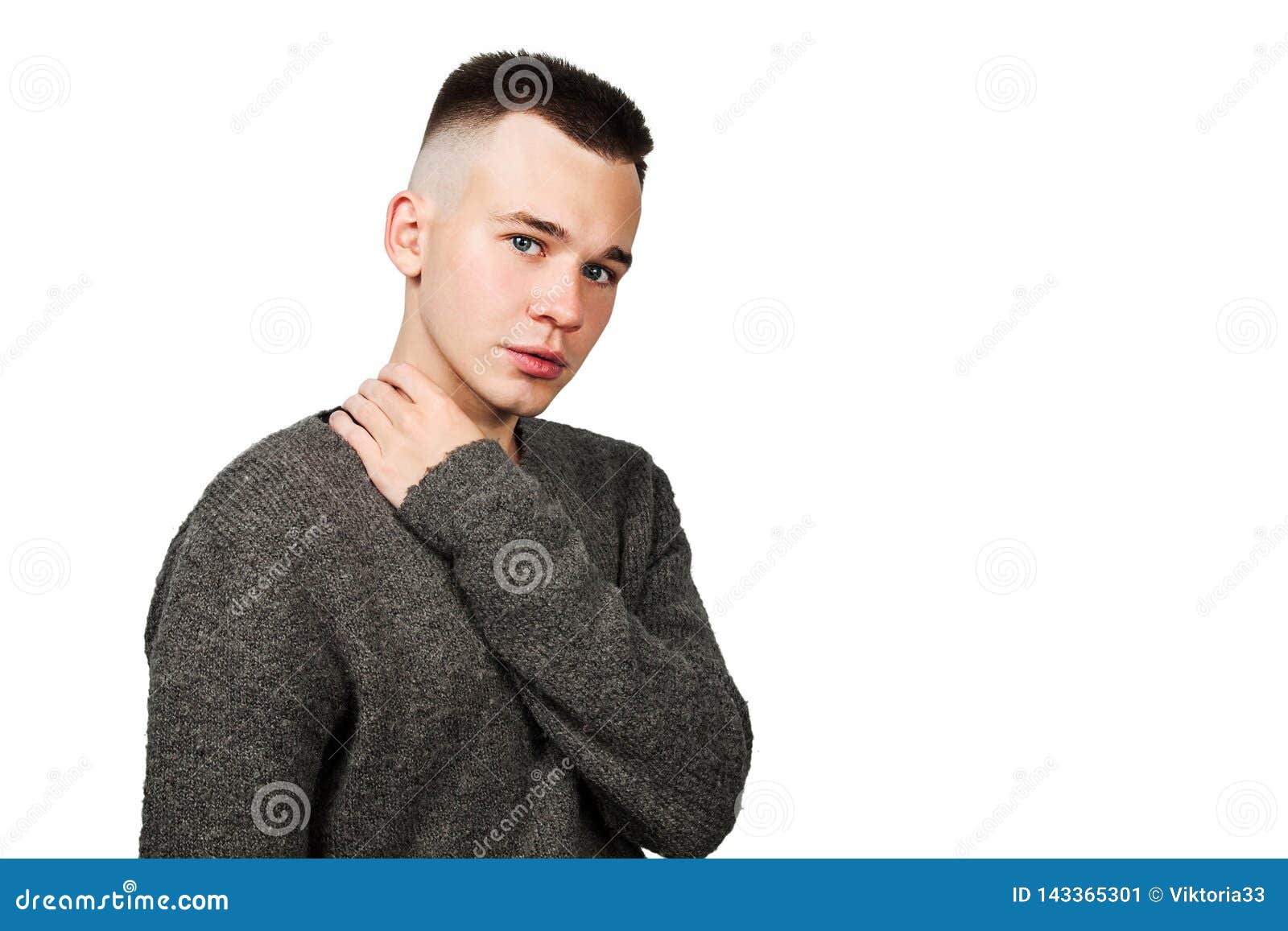 Portrait Of White Yong Guy In Gray Sweater And Short Haircut