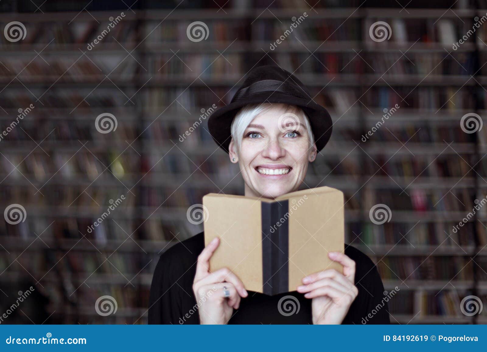Blonde woman writing in library - wide 9