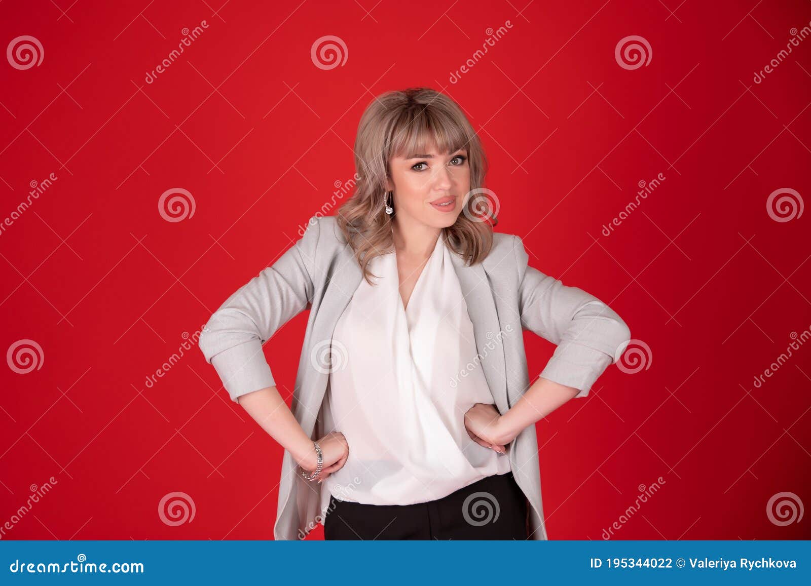 portrait of a woman business blonde in bright jacket on redbackground