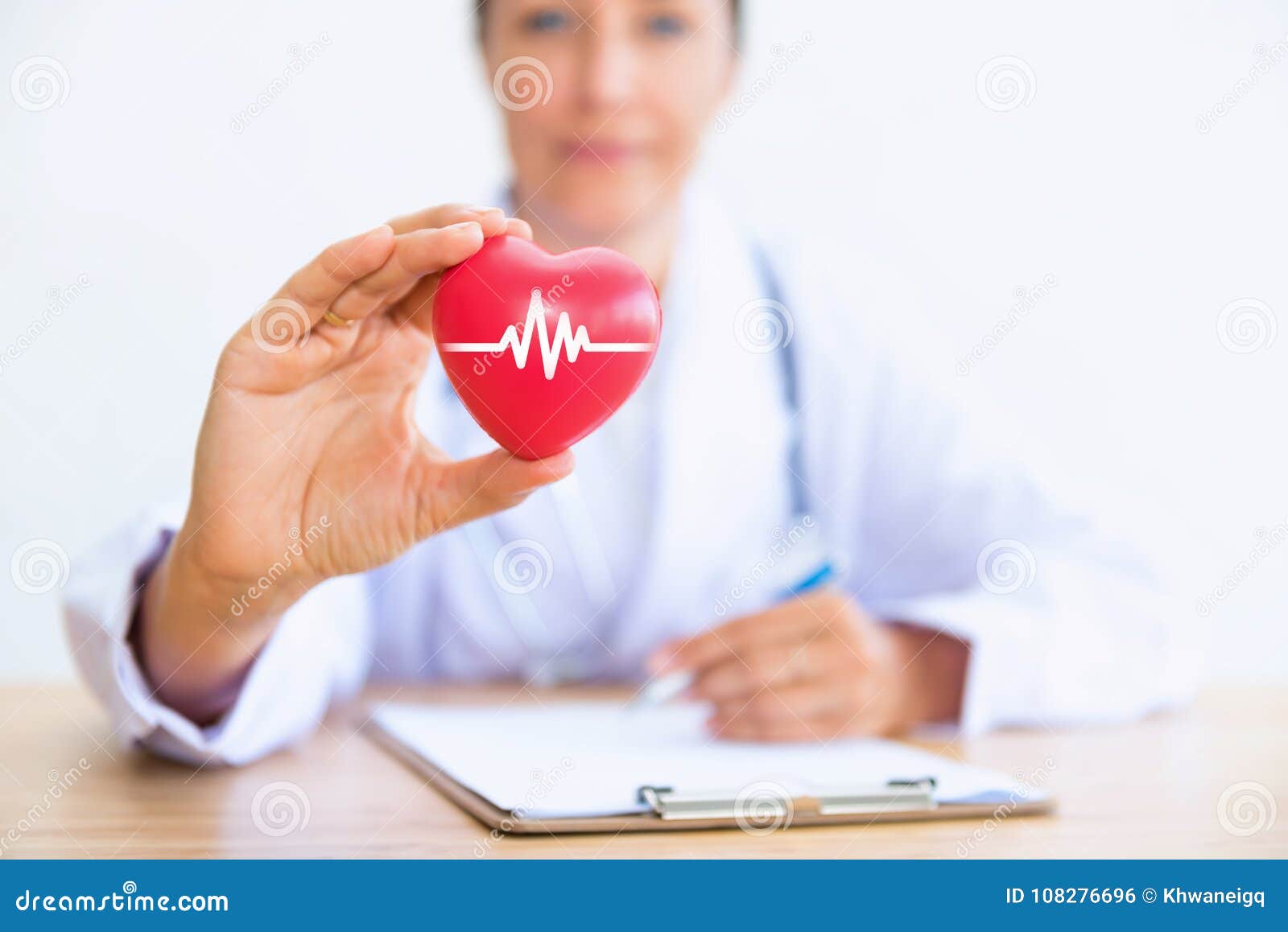 portrait of woman doctor with holding red heart, health care con