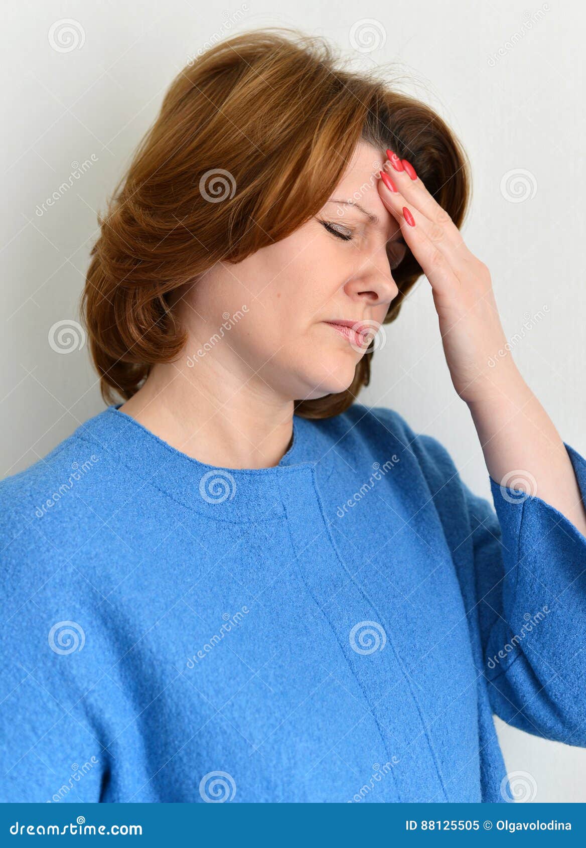 Portrait of a woman experiencing a migraine