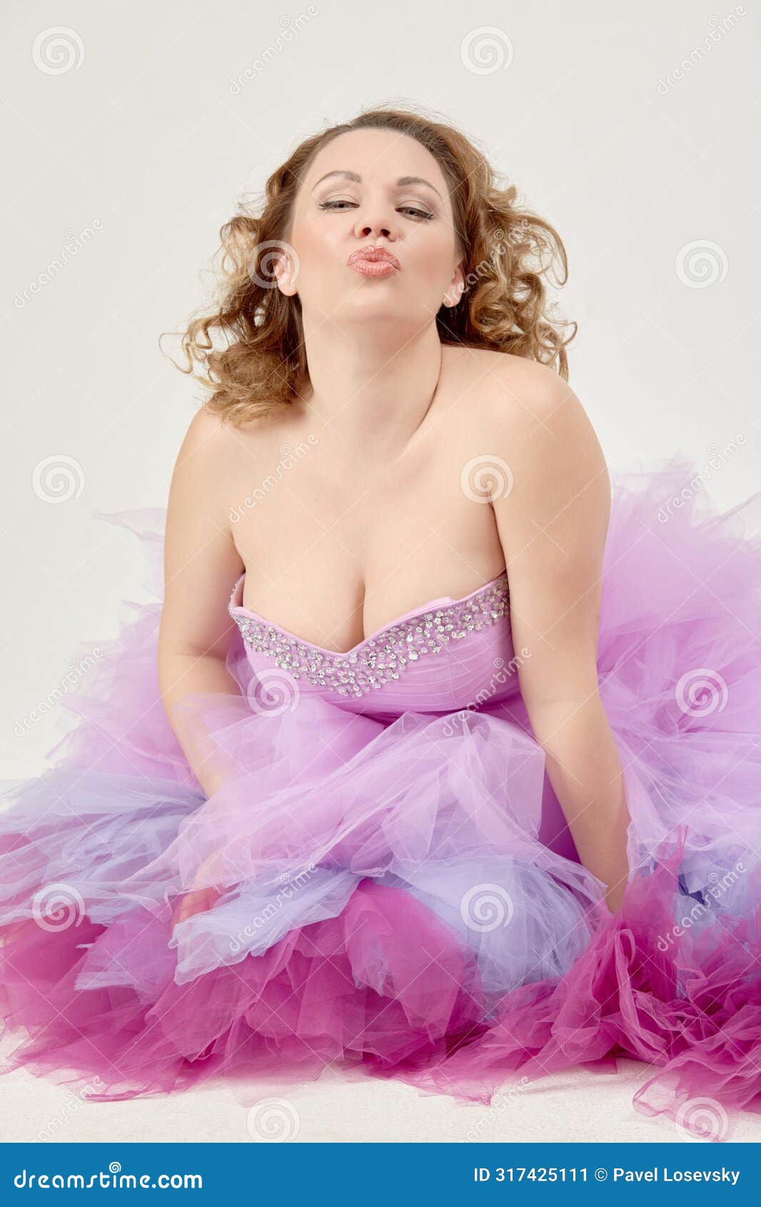 portrait of woman in a fluffy purple dress giving